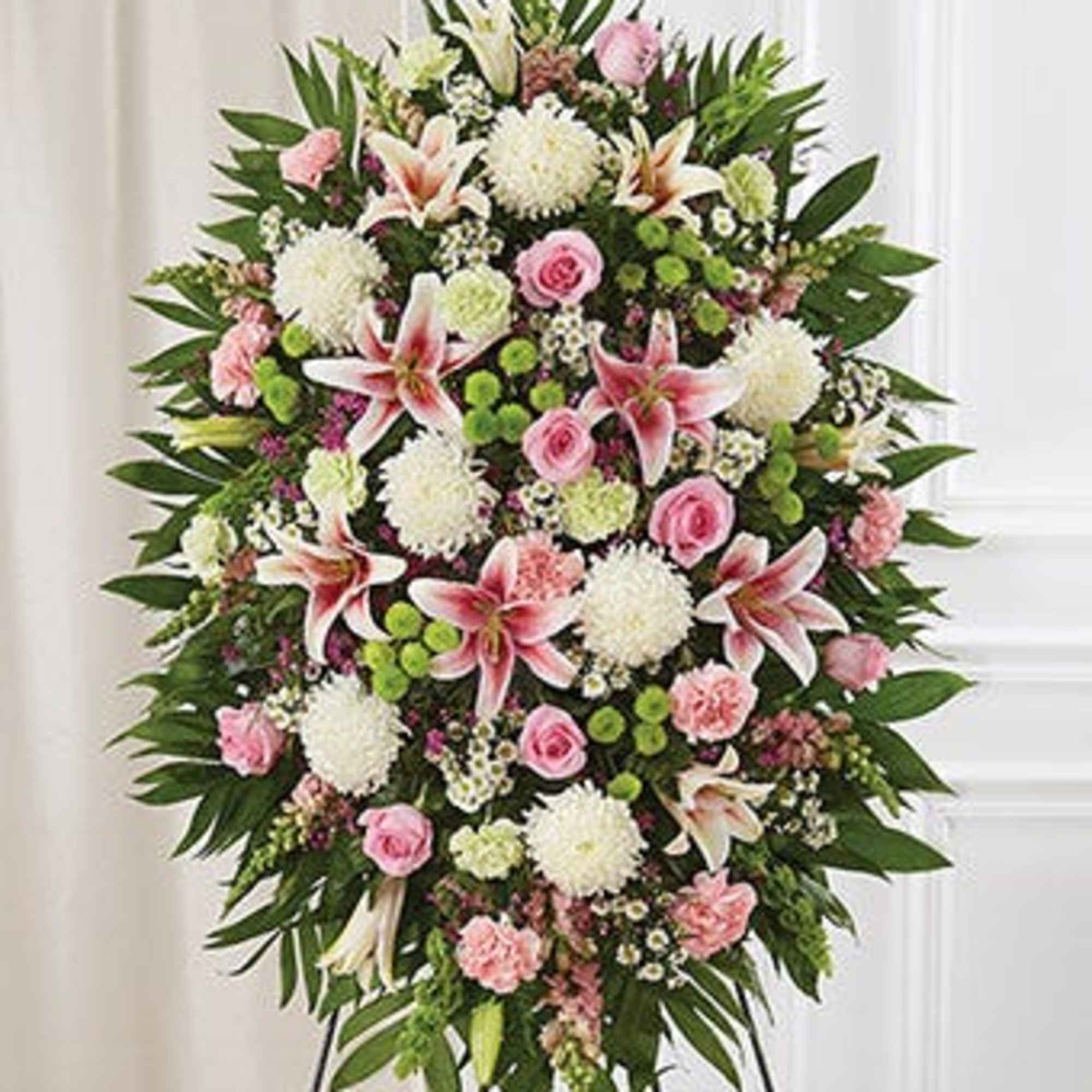 Standing funeral spray with pink and white flowers on an easel