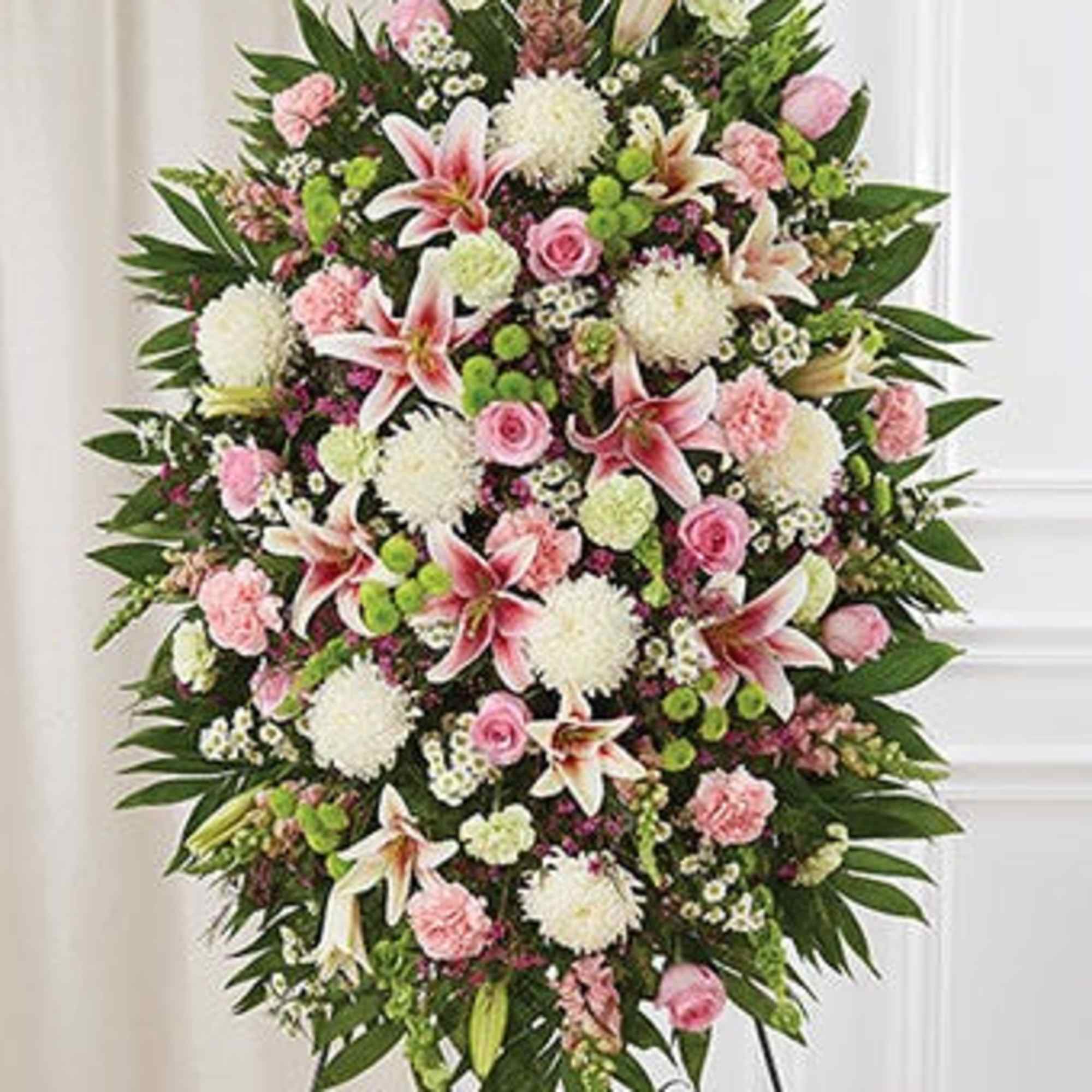 Large standing spray of pink and white flowers on an easel