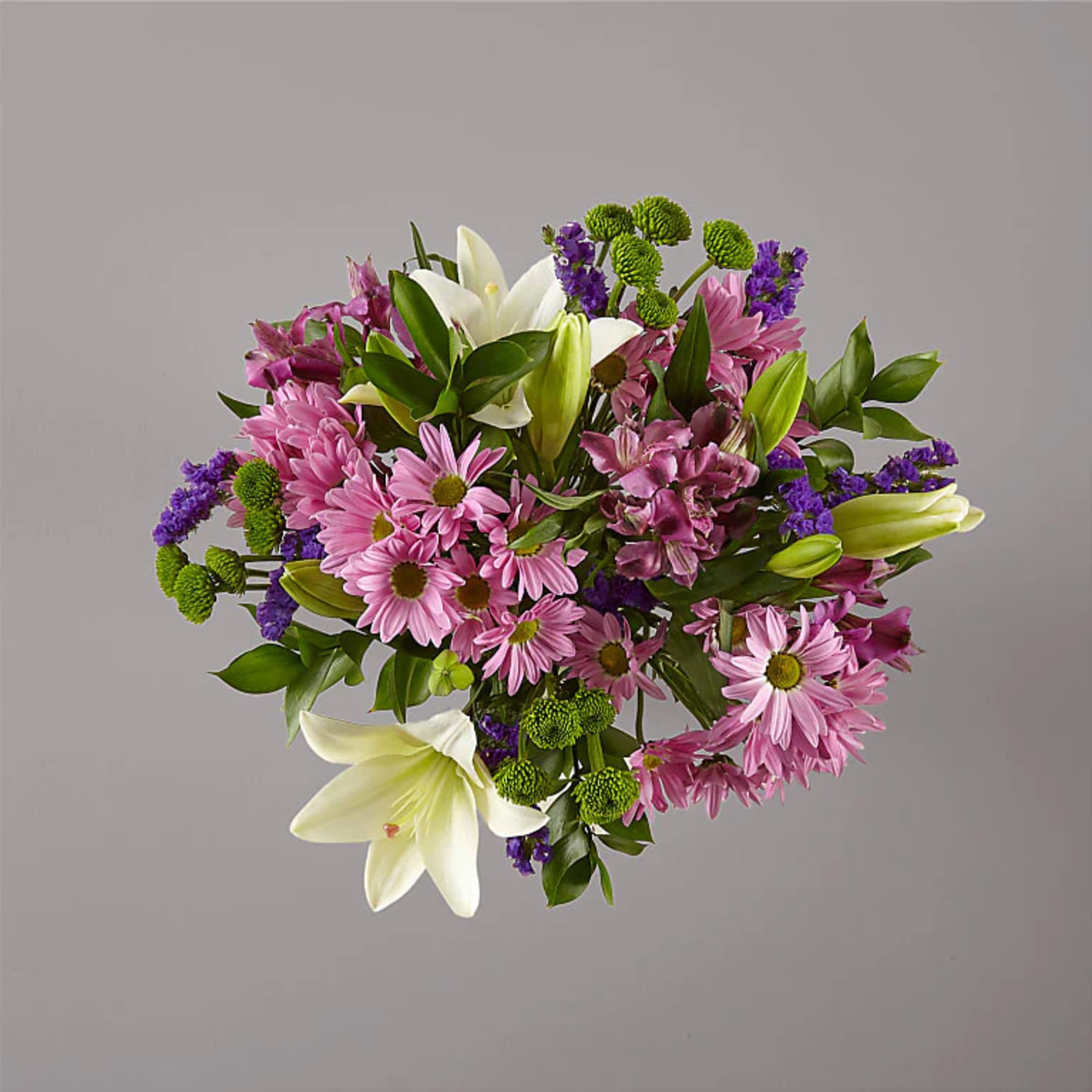 Bouquet of pink daisies, white lilies, and purple filler flowers