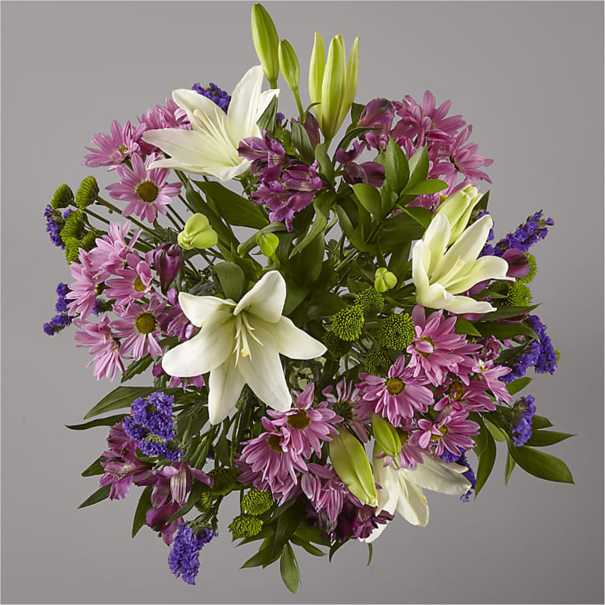 Bouquet of white lilies, pink daisies, and purple filler flowers