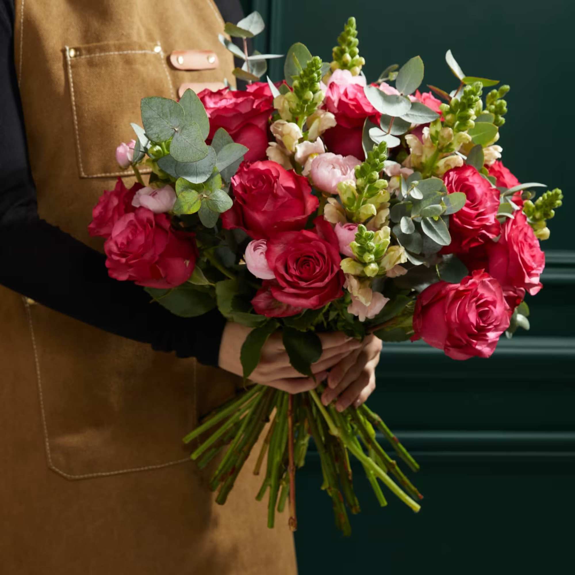 Hand-tied bouquet of pink roses with eucalyptus and snapdragons