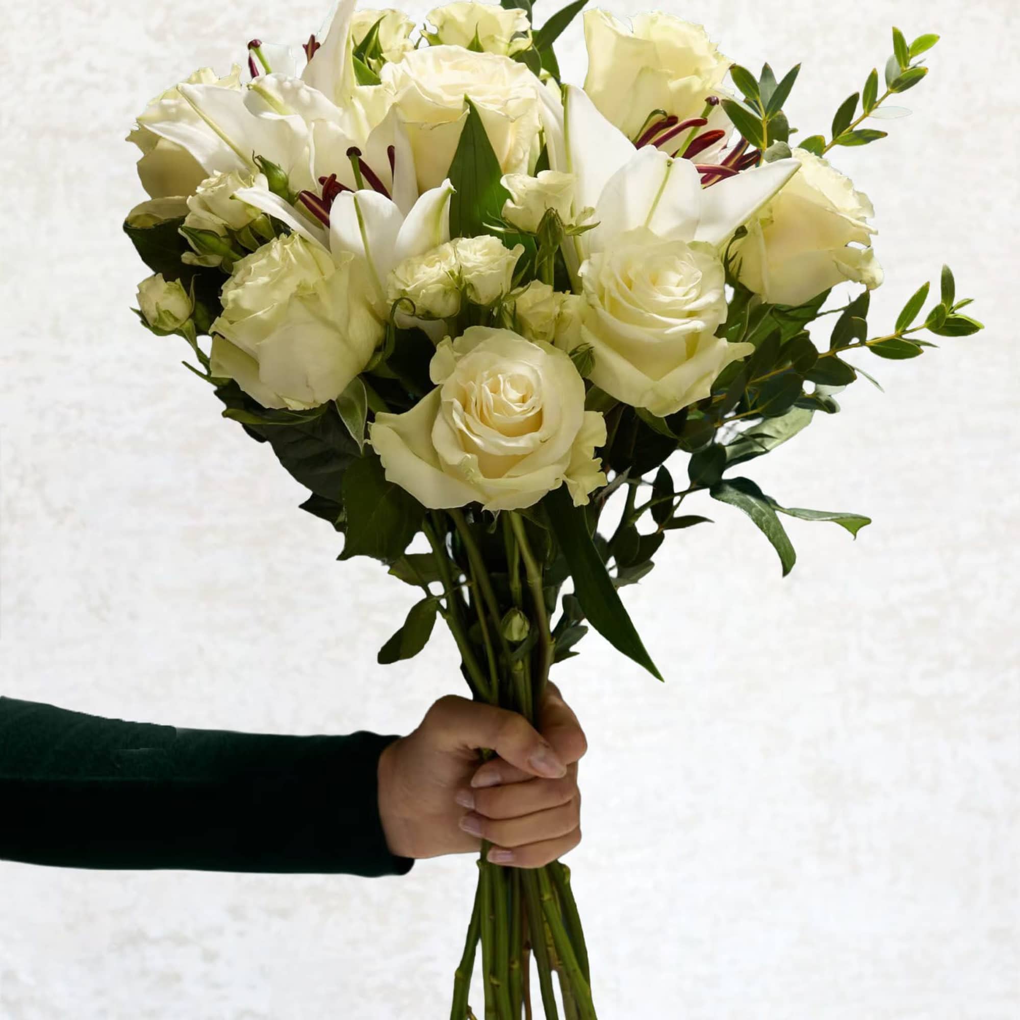 Handheld bouquet of white roses and lilies