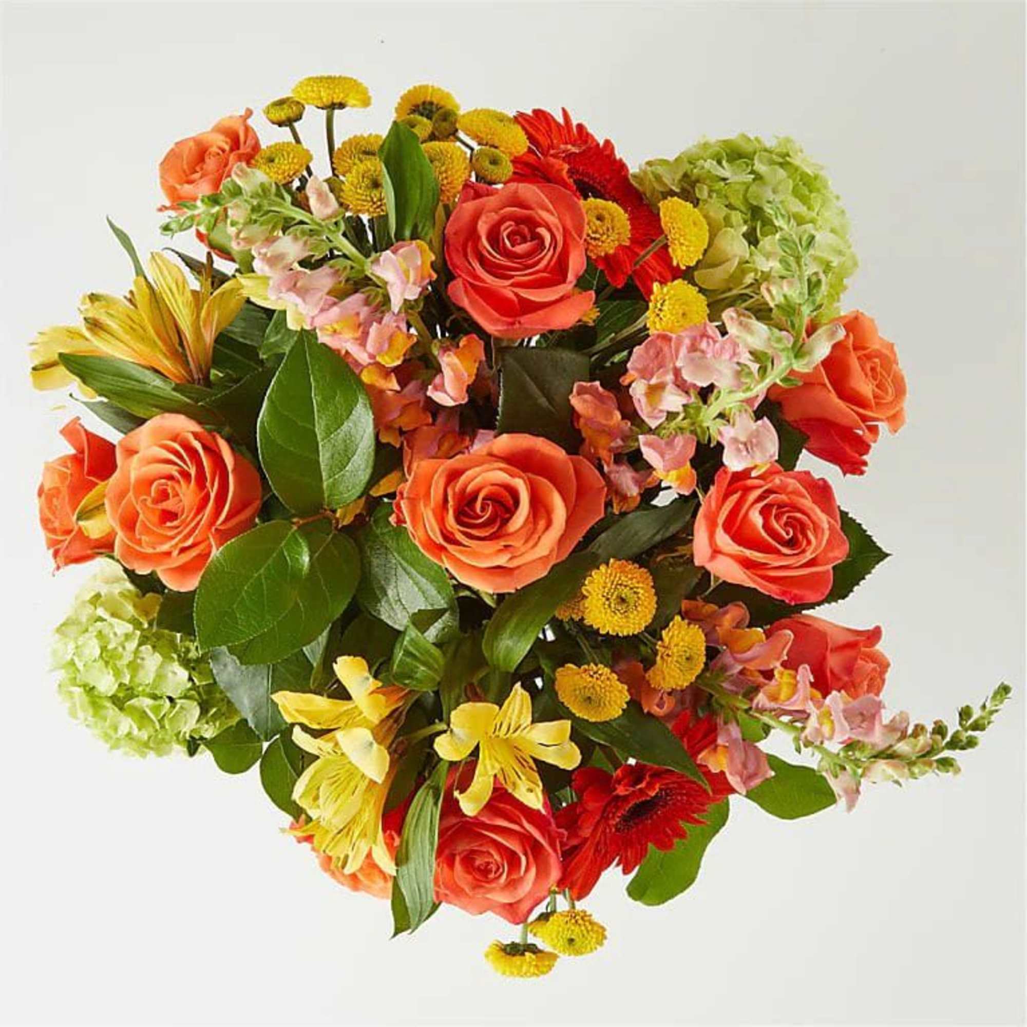 Mixed bouquet with orange roses, yellow blooms, and green hydrangeas