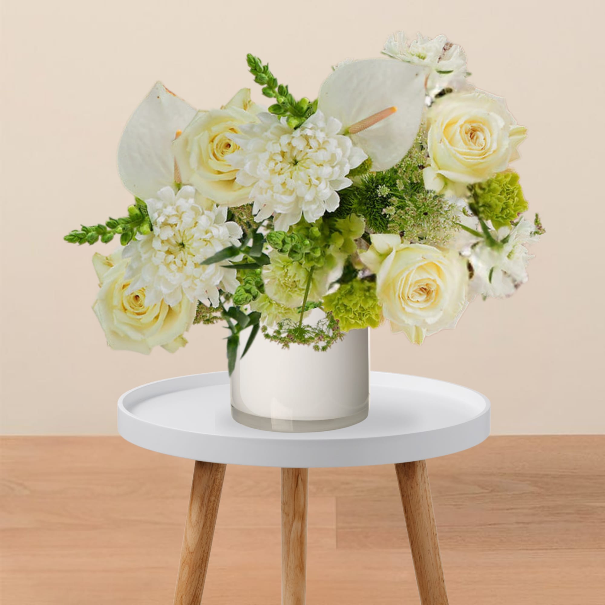 White roses and calla lilies in a glass vase
