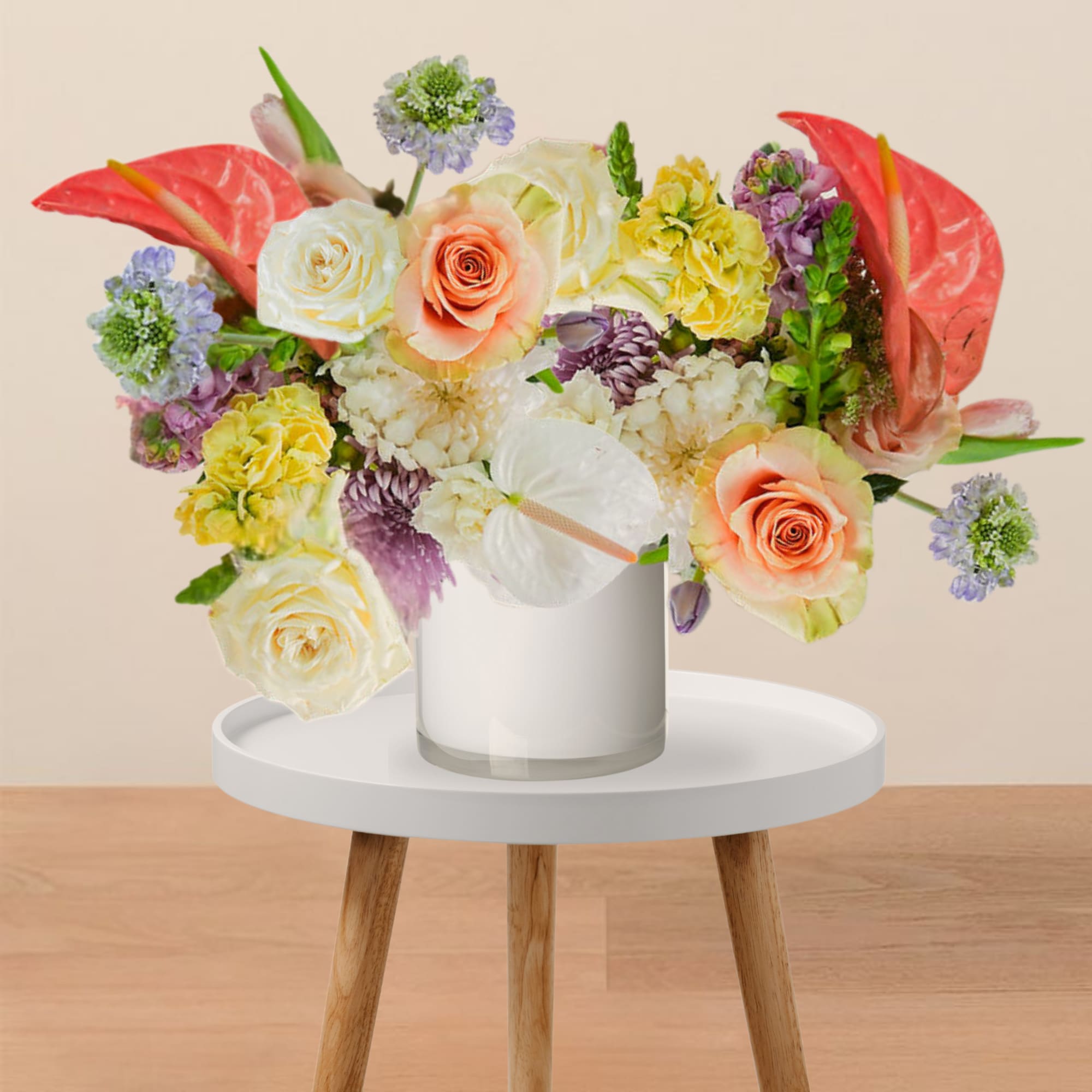 Mixed bouquet of roses and other flowers in a glass vase