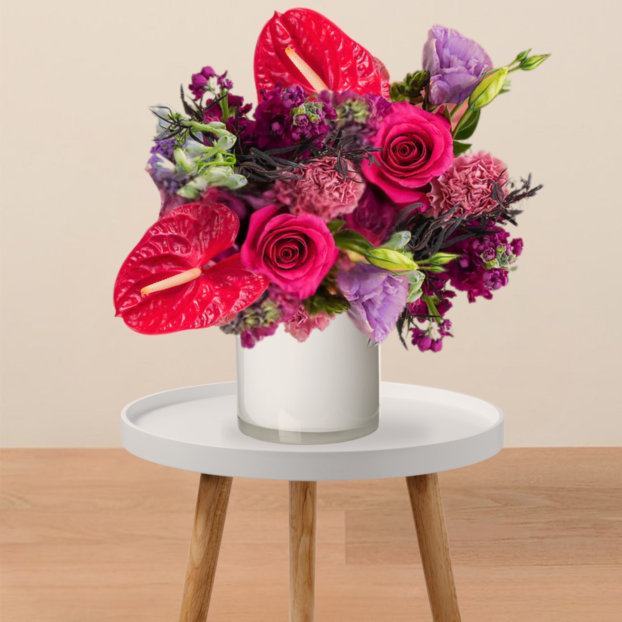 Bright pink bouquet with roses and anthuriums in a white vase
