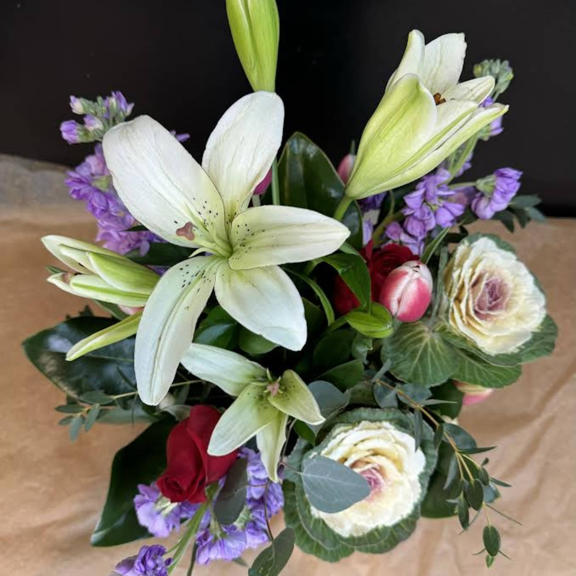 Bouquet of white lilies, roses, and purple flowers