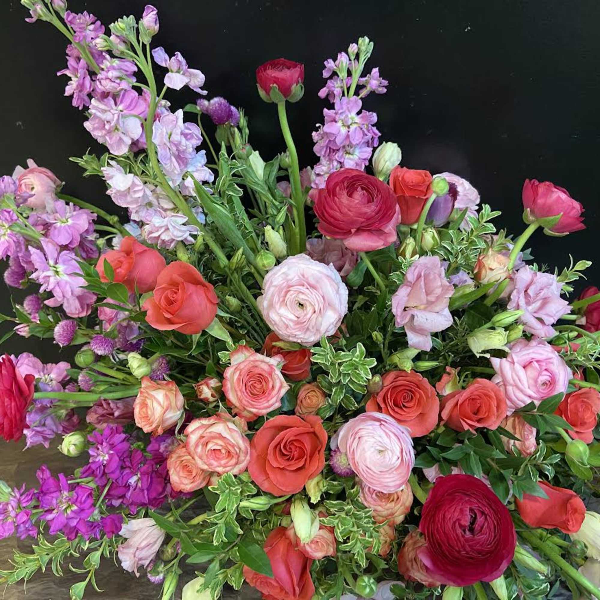 Mixed bouquet of pink, red, and lavender flowers