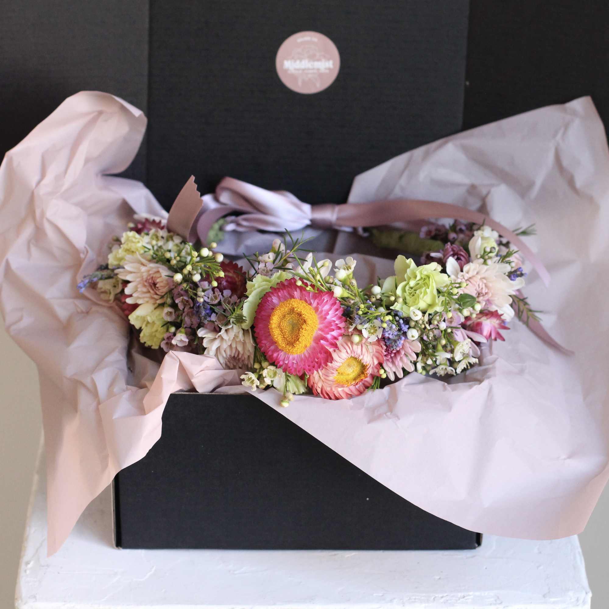 Pink and white mixed flower bouquet wrapped in pale pink paper