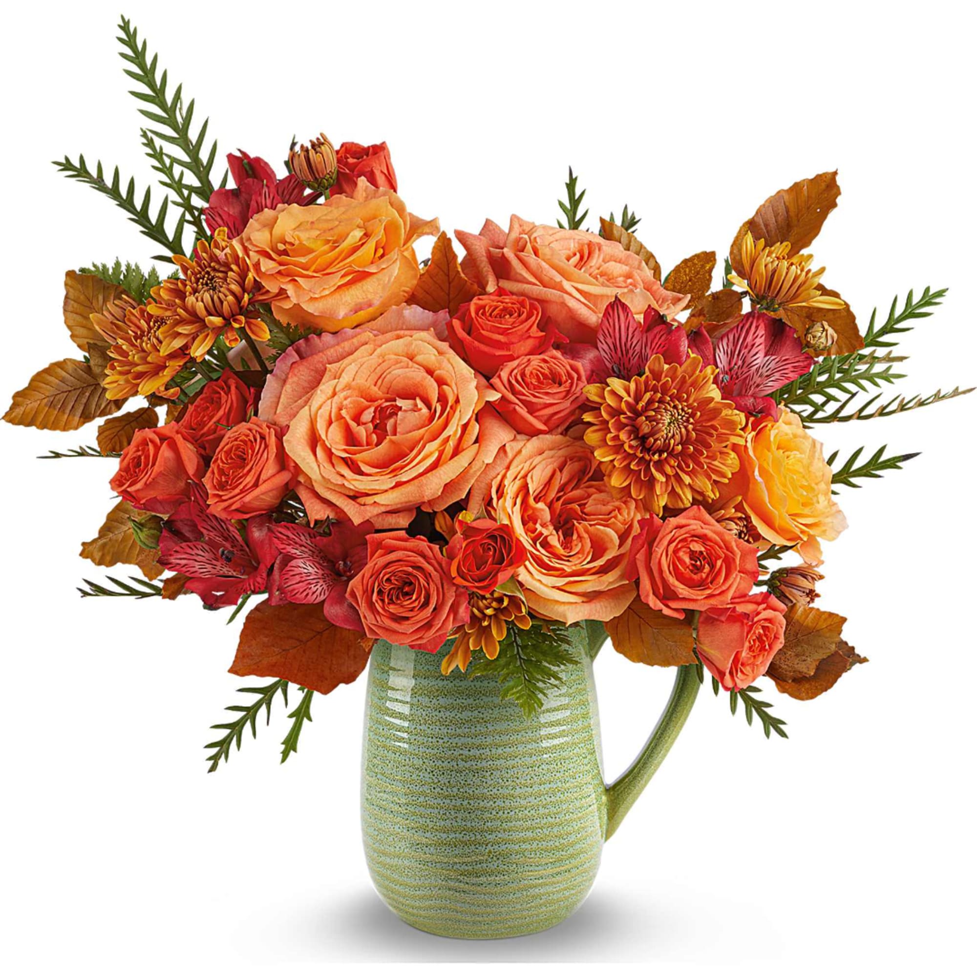 Orange and red flower arrangement in a green ceramic pitcher vase