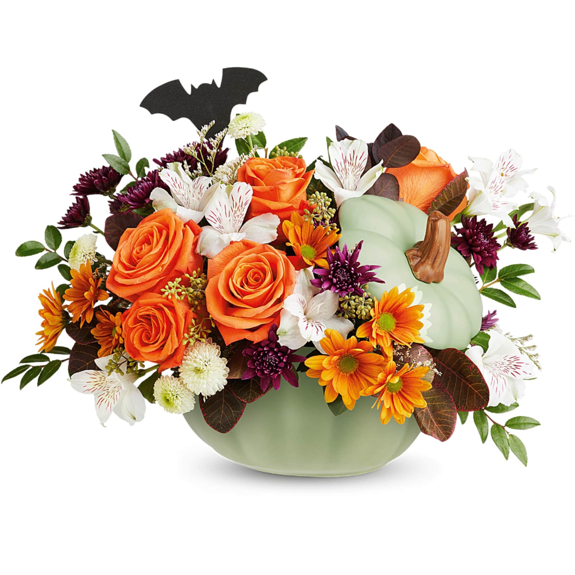 Orange roses and mixed fall flowers in a pale green pumpkin vase with a bat topper