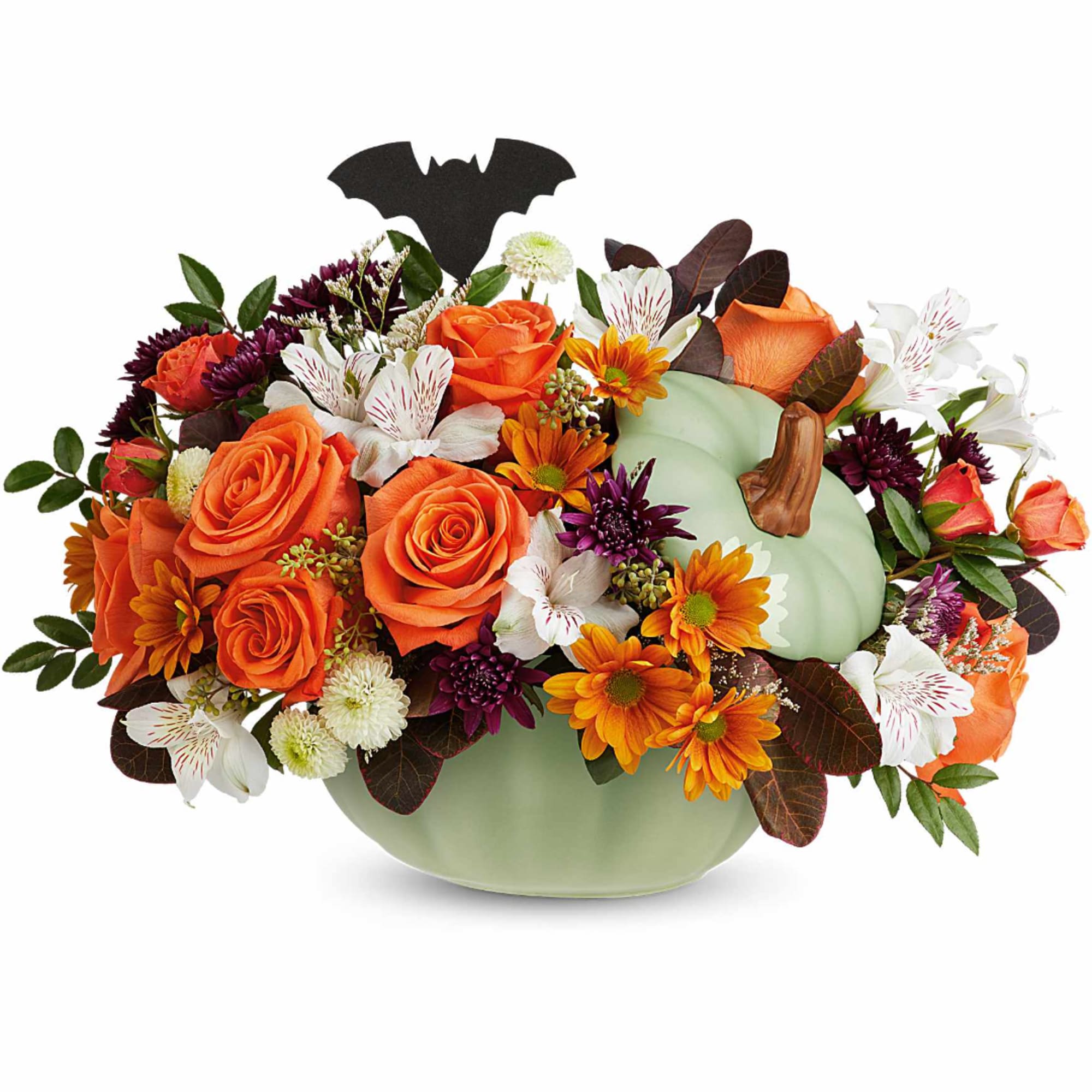 Orange and white floral arrangement in a pale green pumpkin vase with a bat topper