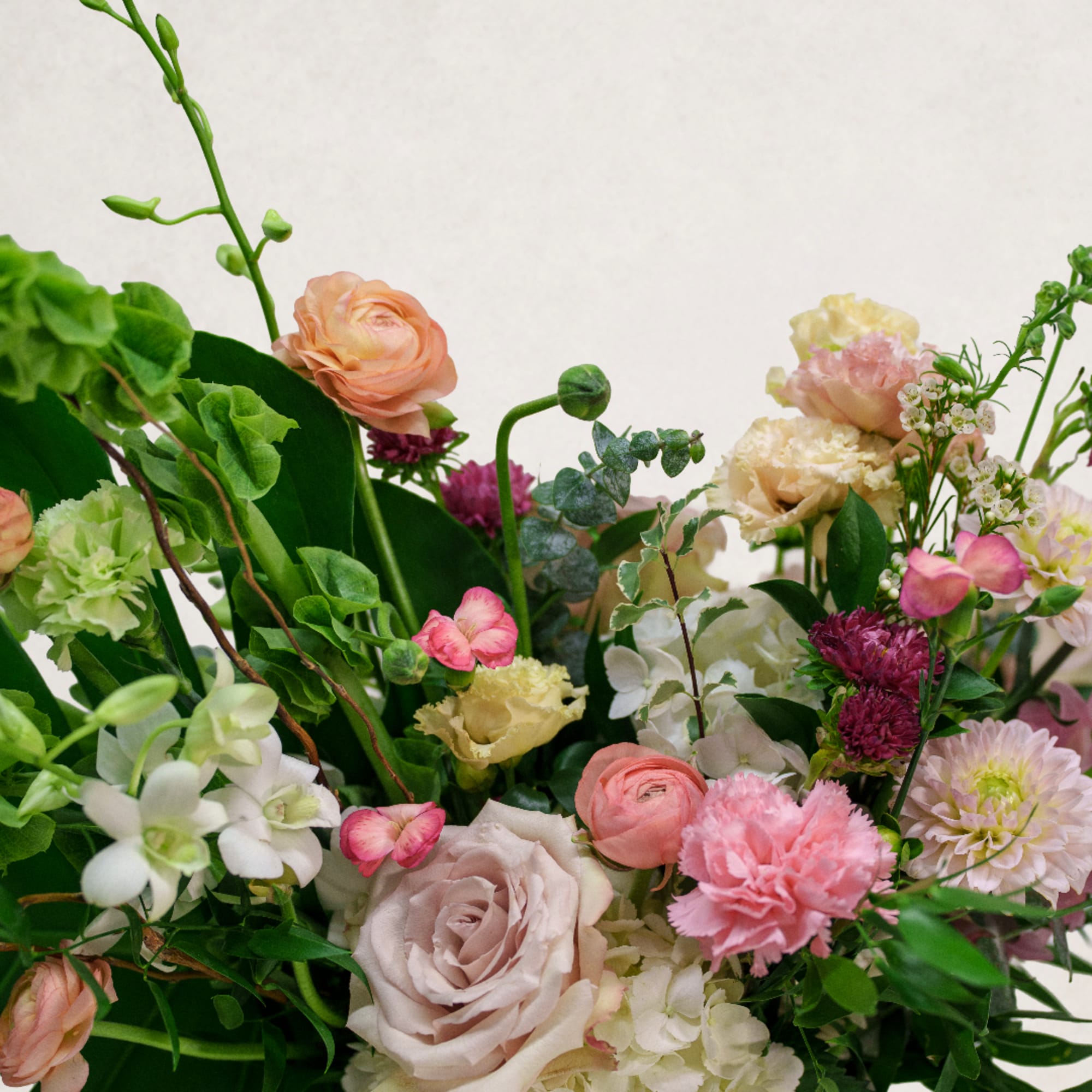 Mixed bouquet with pink, peach, white, and green flowers