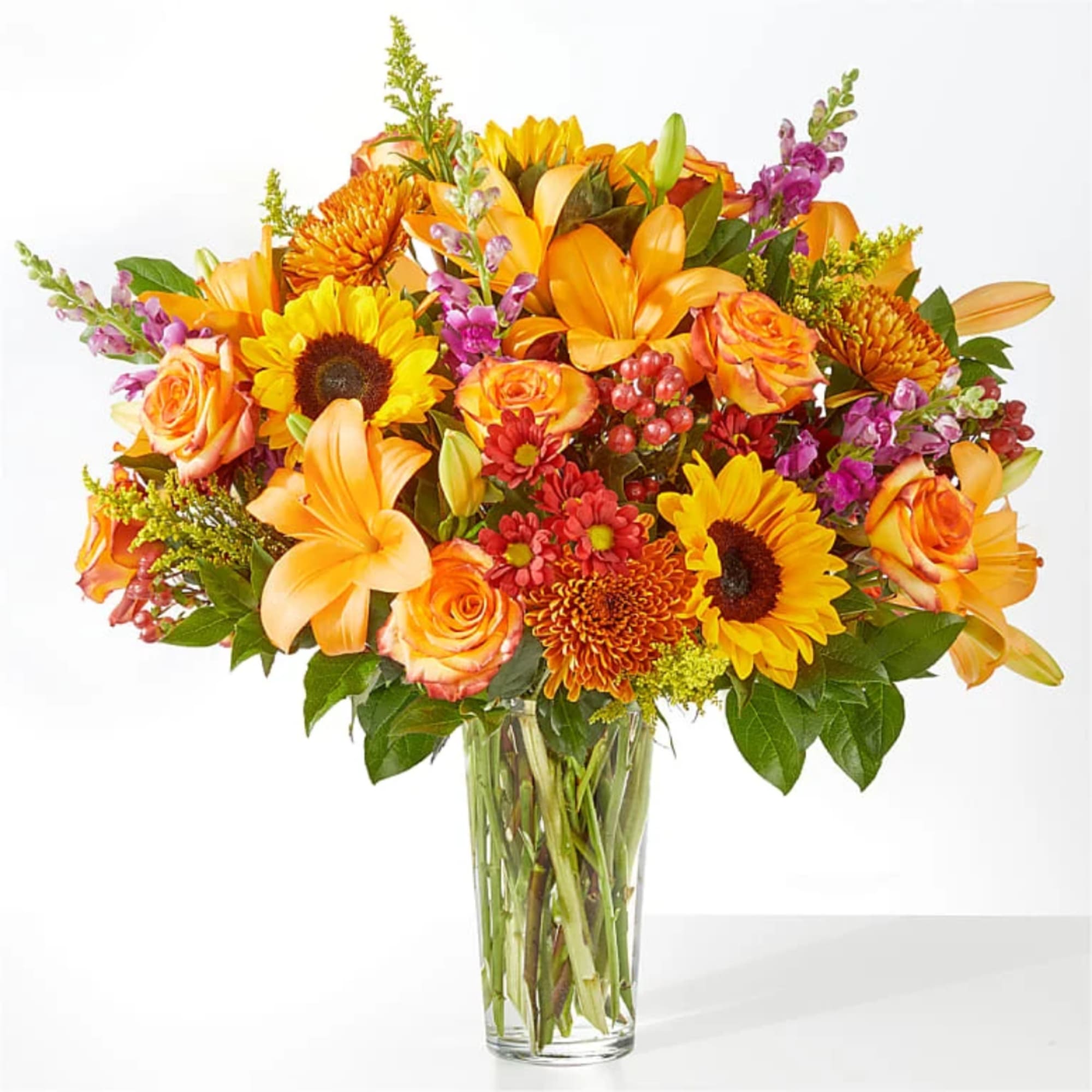 Orange and yellow mixed bouquet in a clear glass vase