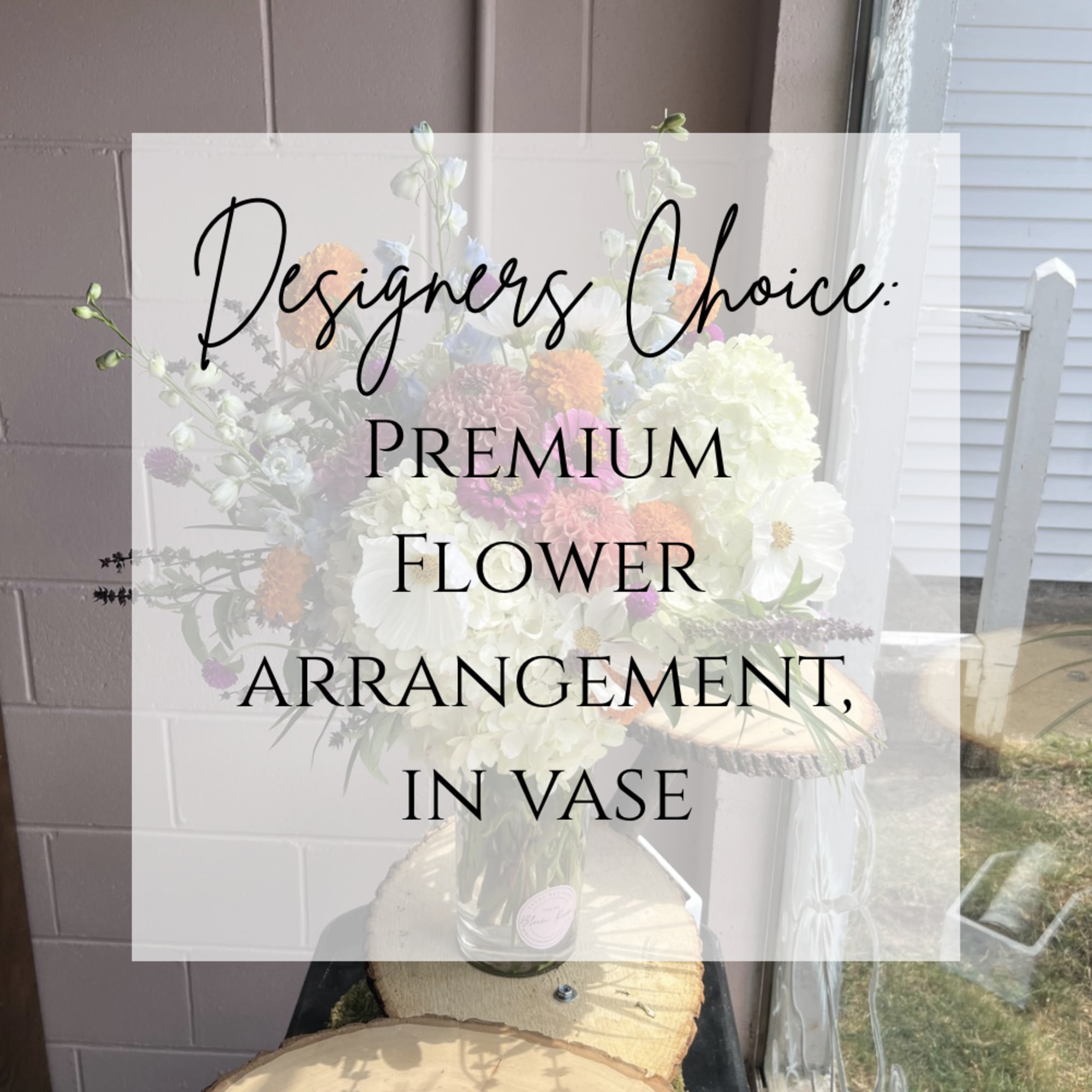 Mixed flower arrangement in a clear vase with white and pastel blooms