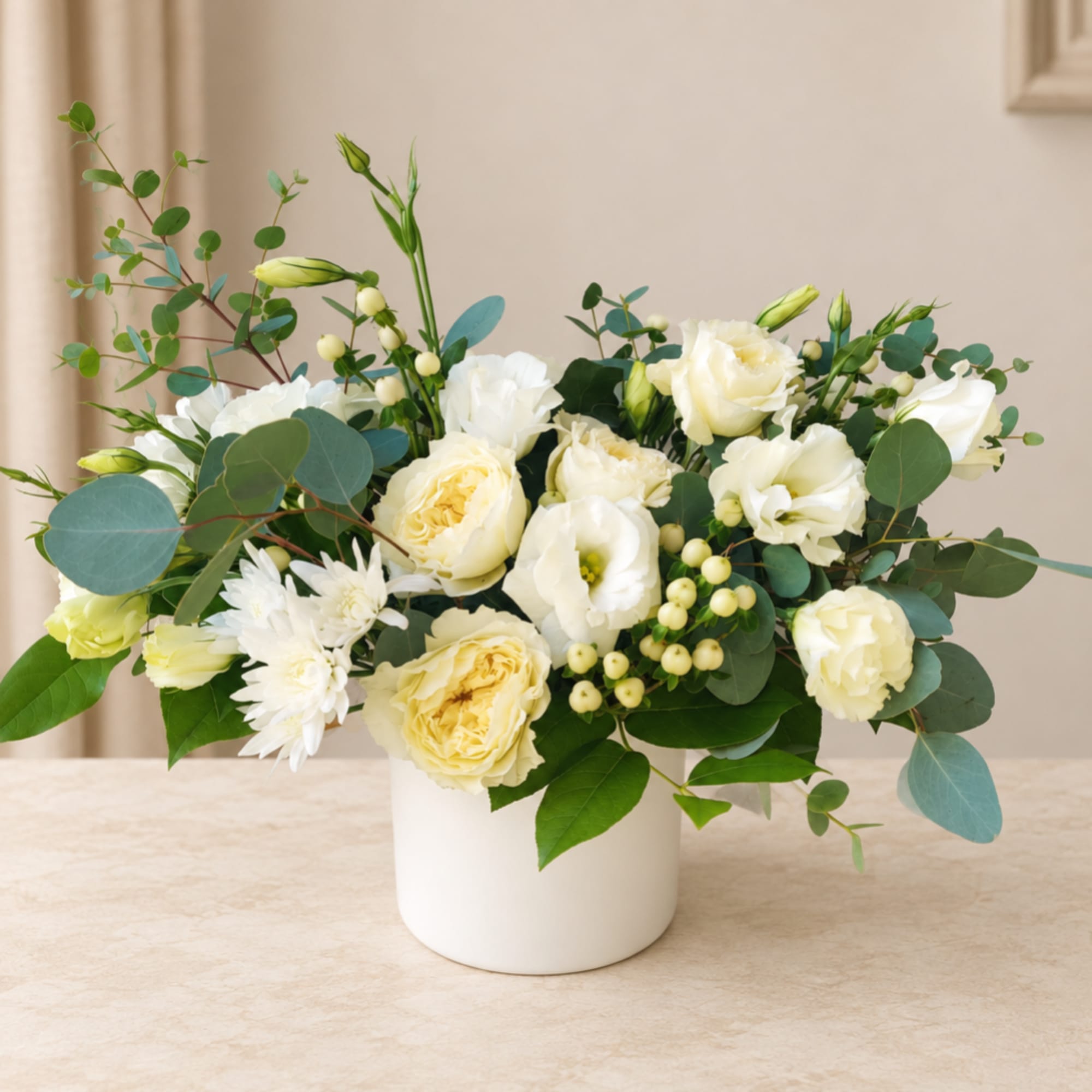 White and pale yellow bouquet in a white vase