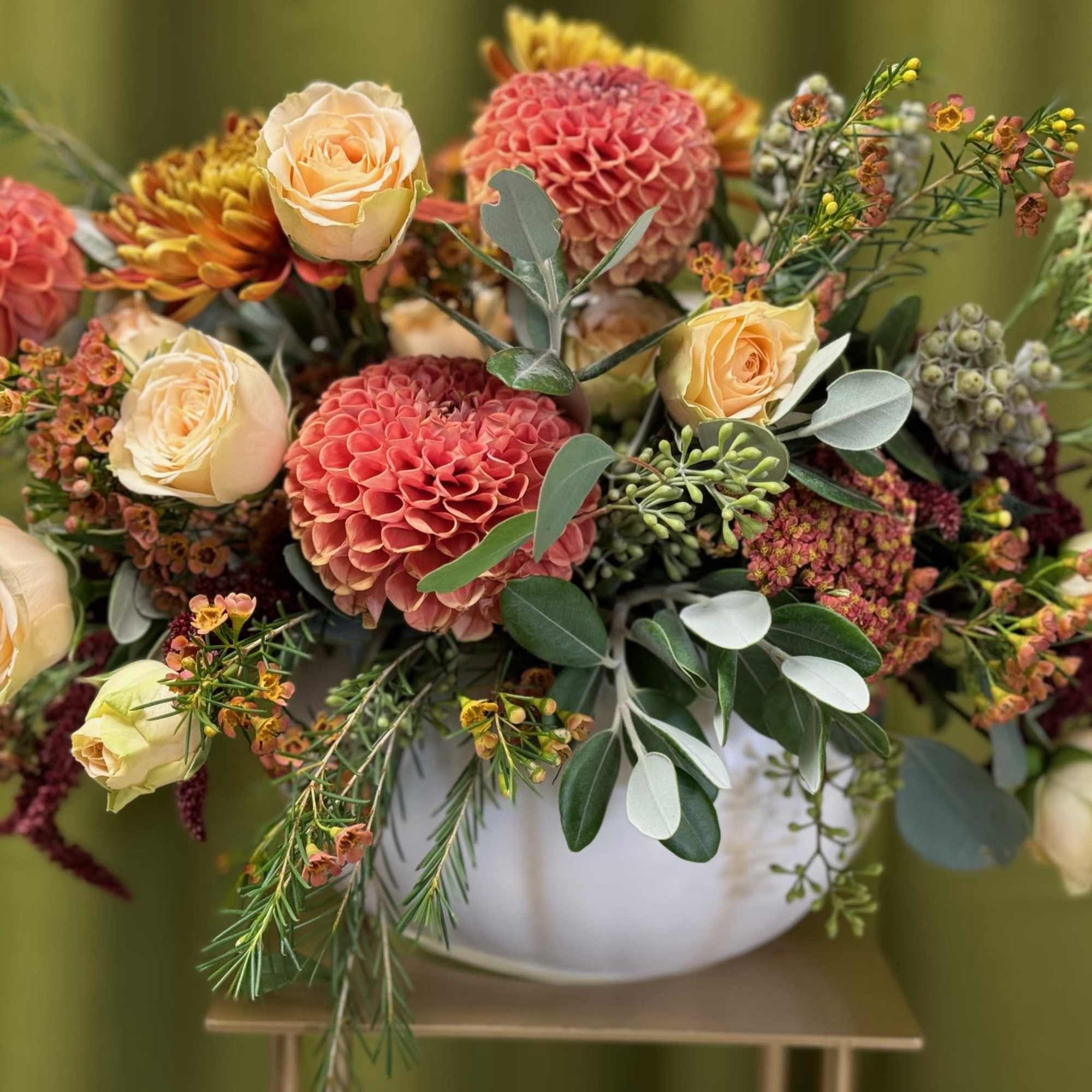 Dahlias, Disbuds, Spray roses, Yarrow, Wax, and Greenery arranged in a White, photo 2 of 3