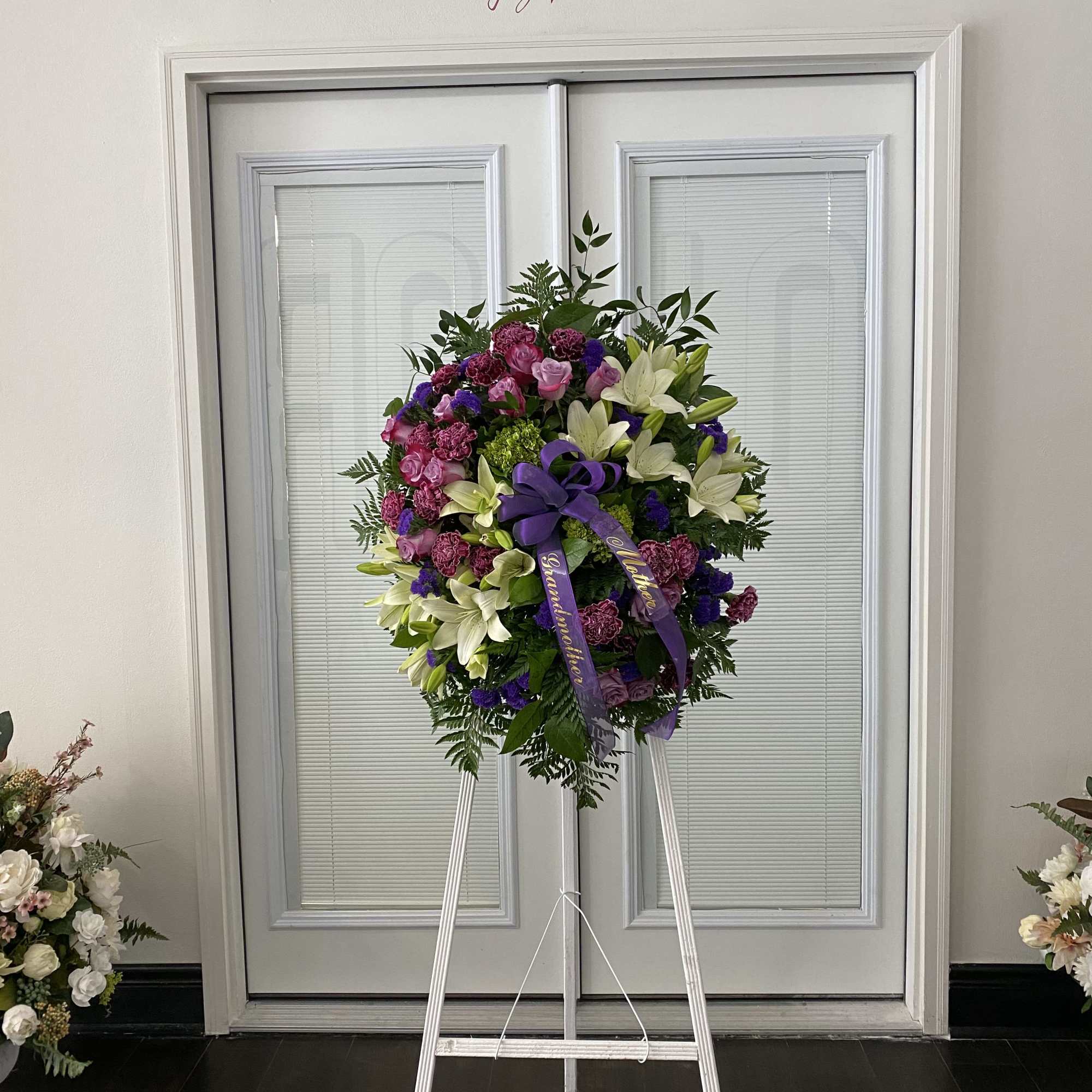 Lovely Memories in Lavender Standing Spray with lavender rose, white lilies, purple