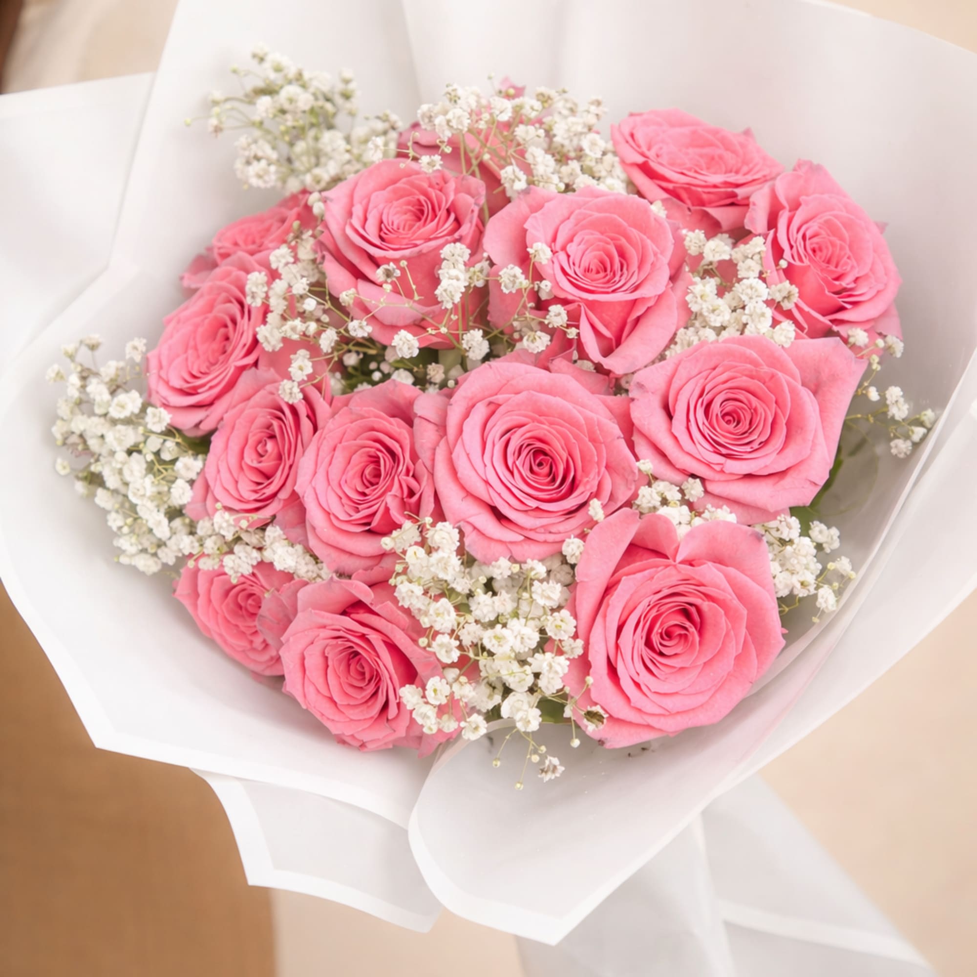 Striking bouquet featuring 12 premium red roses, imported from Ecuador, wrapped in