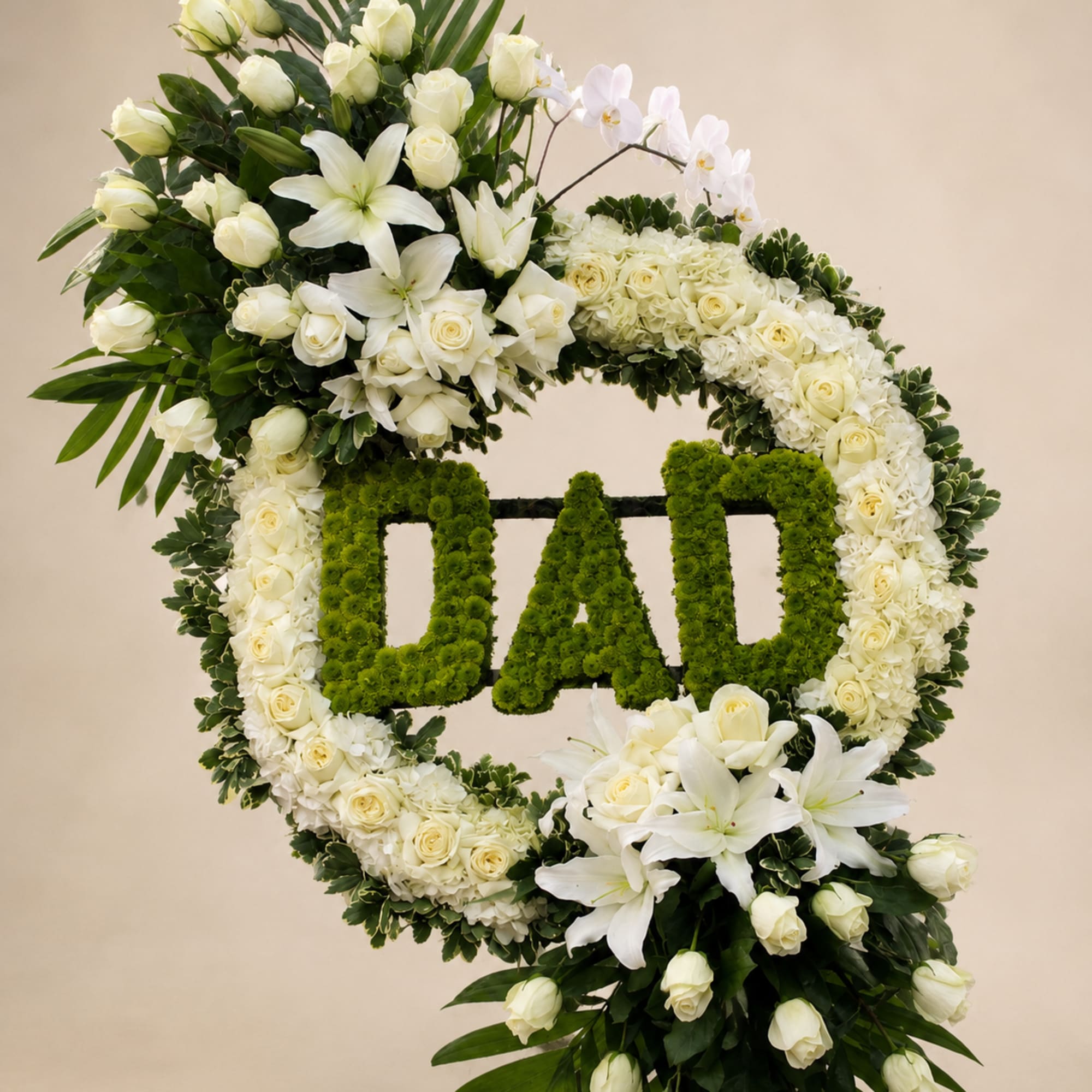 A dignified memorial wreath crafted in white and green for a father