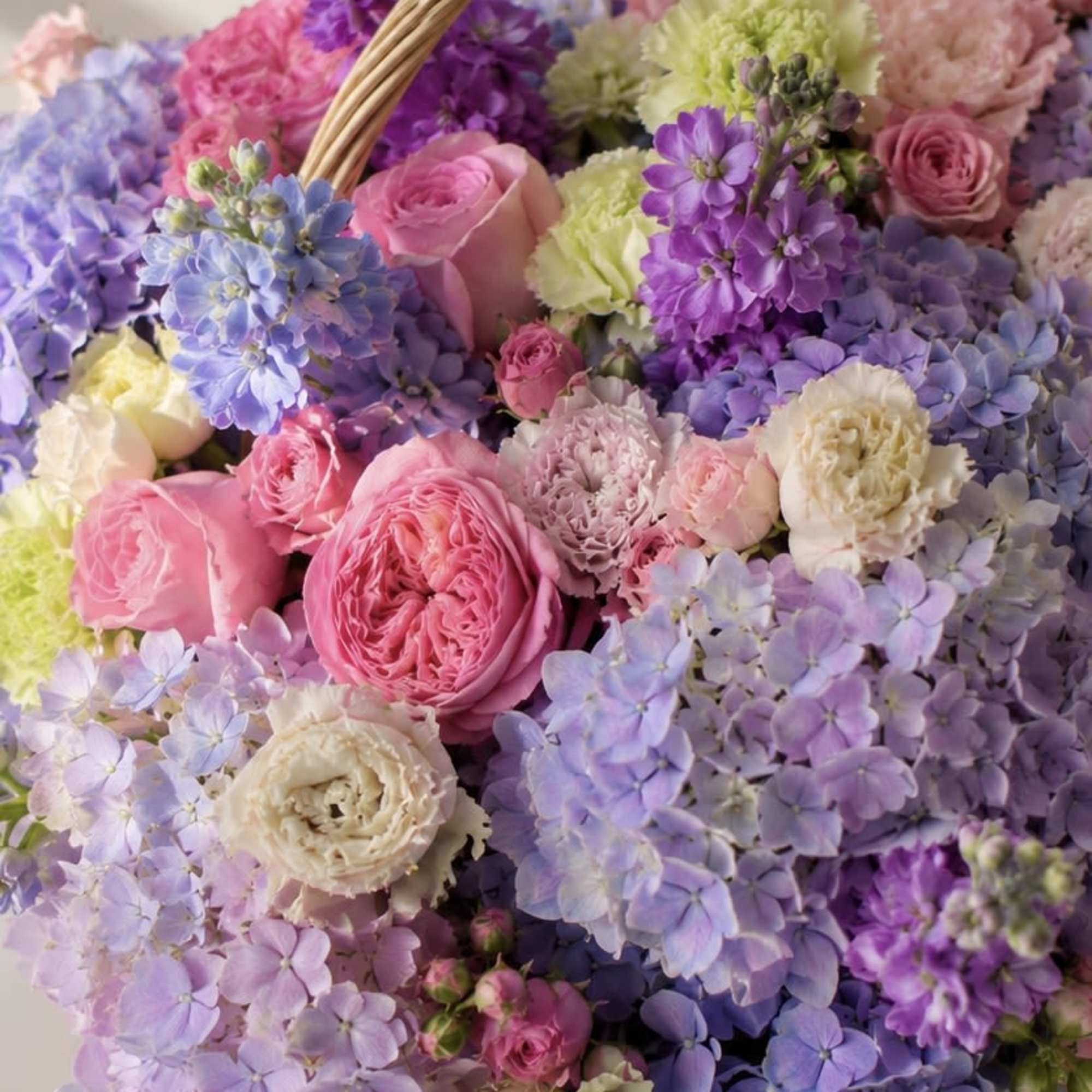 A soft, garden-fresh surprise arranged in a woven wicker basket with a, photo 3 of 3