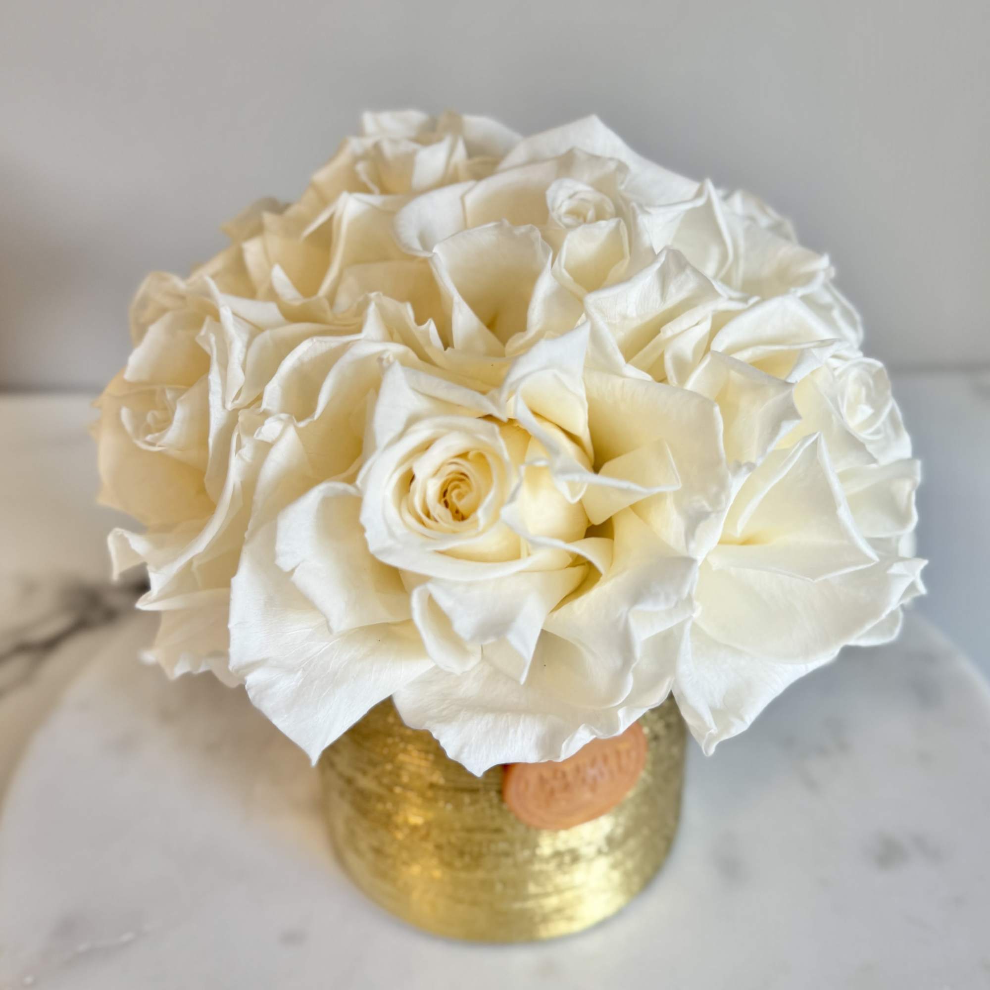 Cream rose bouquet in a gold vase