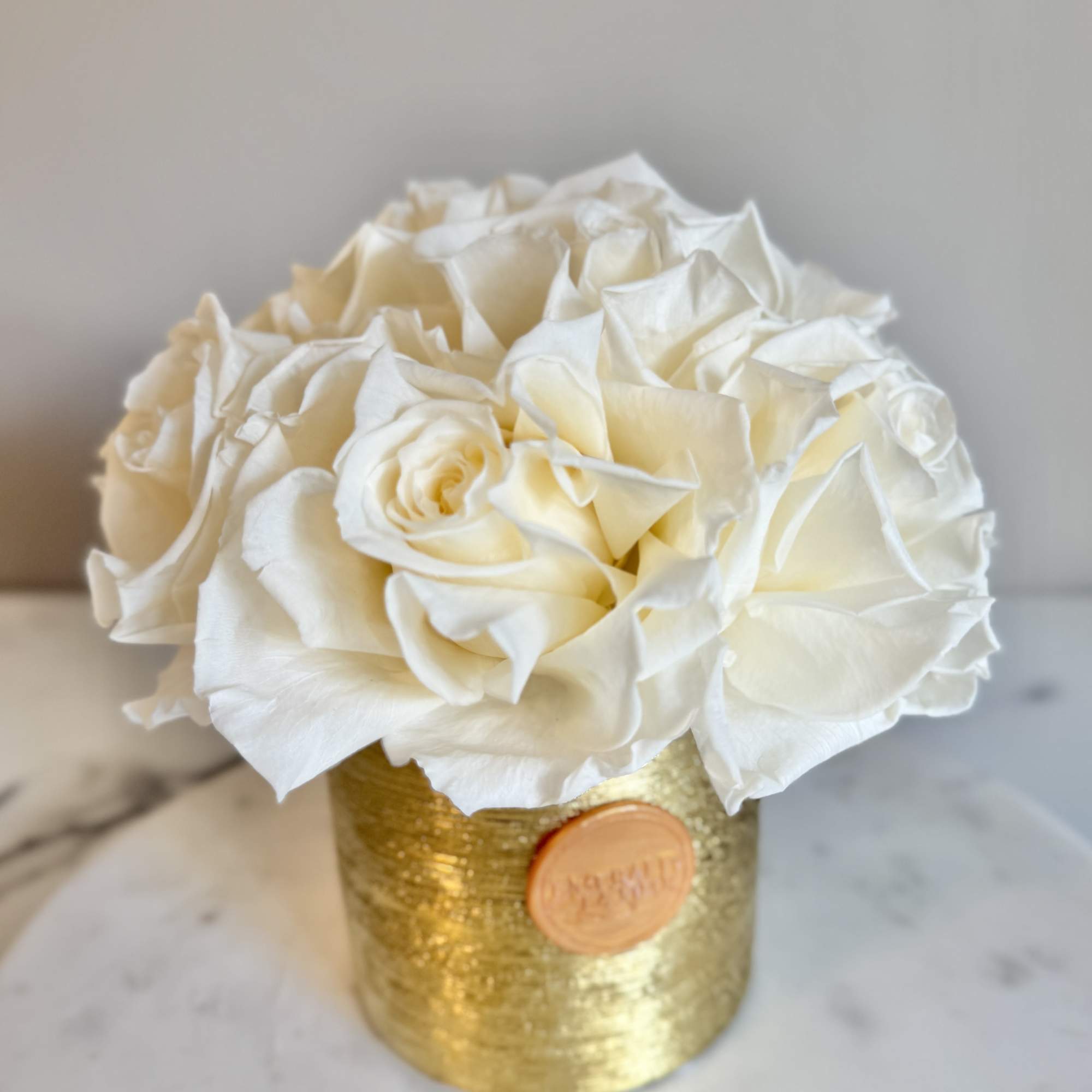 White rose bouquet in a gold container