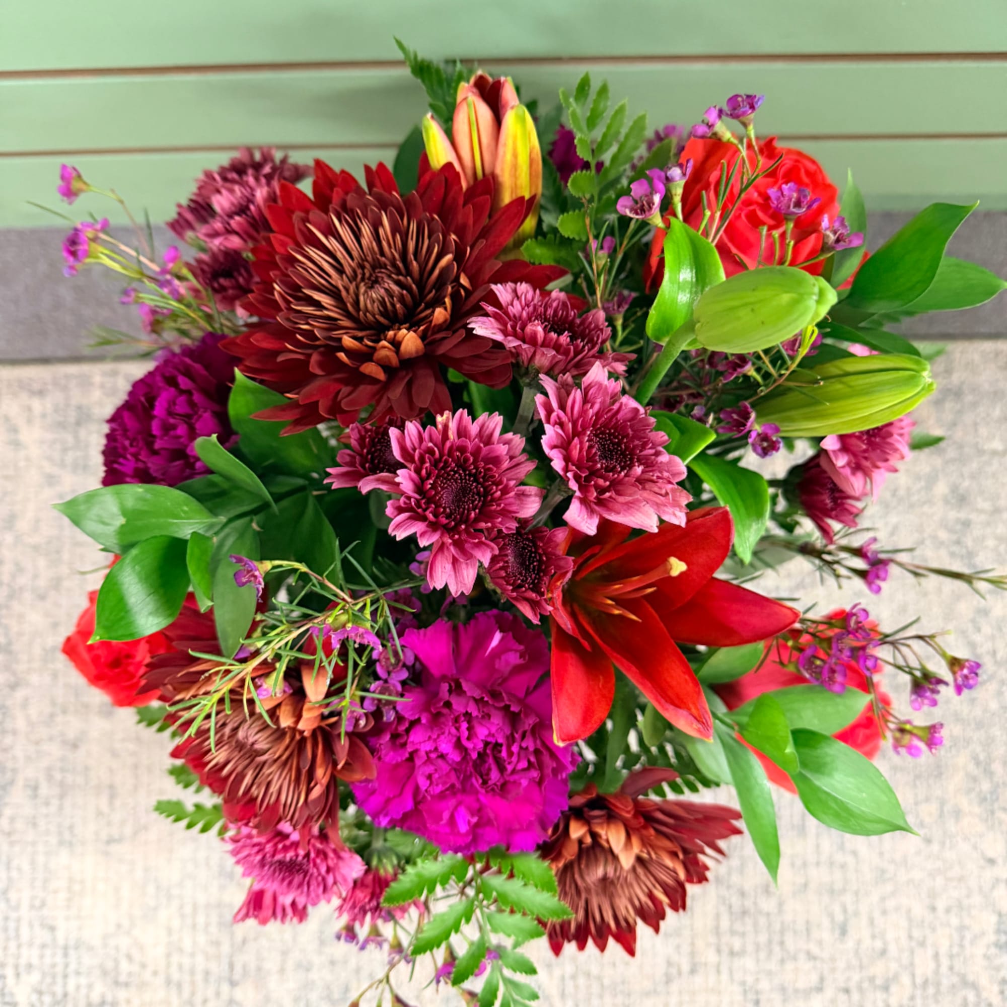 Mixed bouquet with red lilies, pink chrysanthemums, and purple carnations