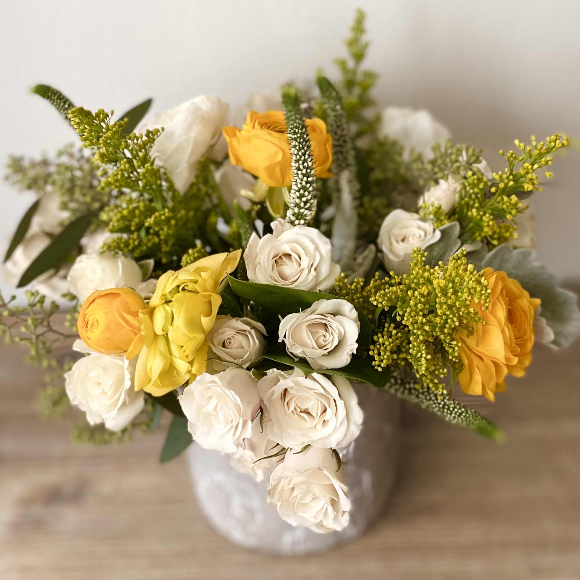 Yellow and white rose bouquet in a white vase