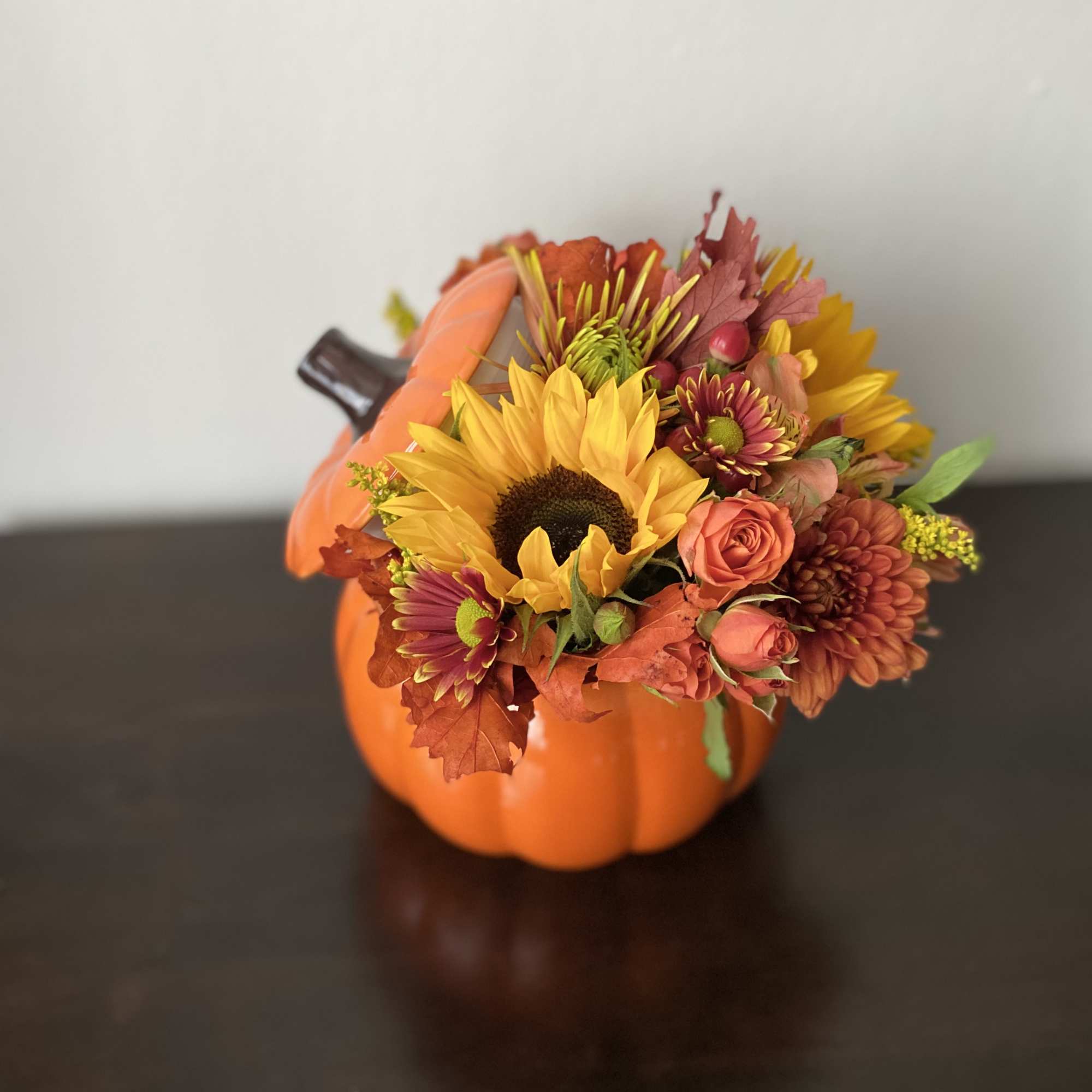 Approximately 11&rdquo; wide, 10&rdquo; tall 

Festive pumpkin with spray roses moms, sunflowers
