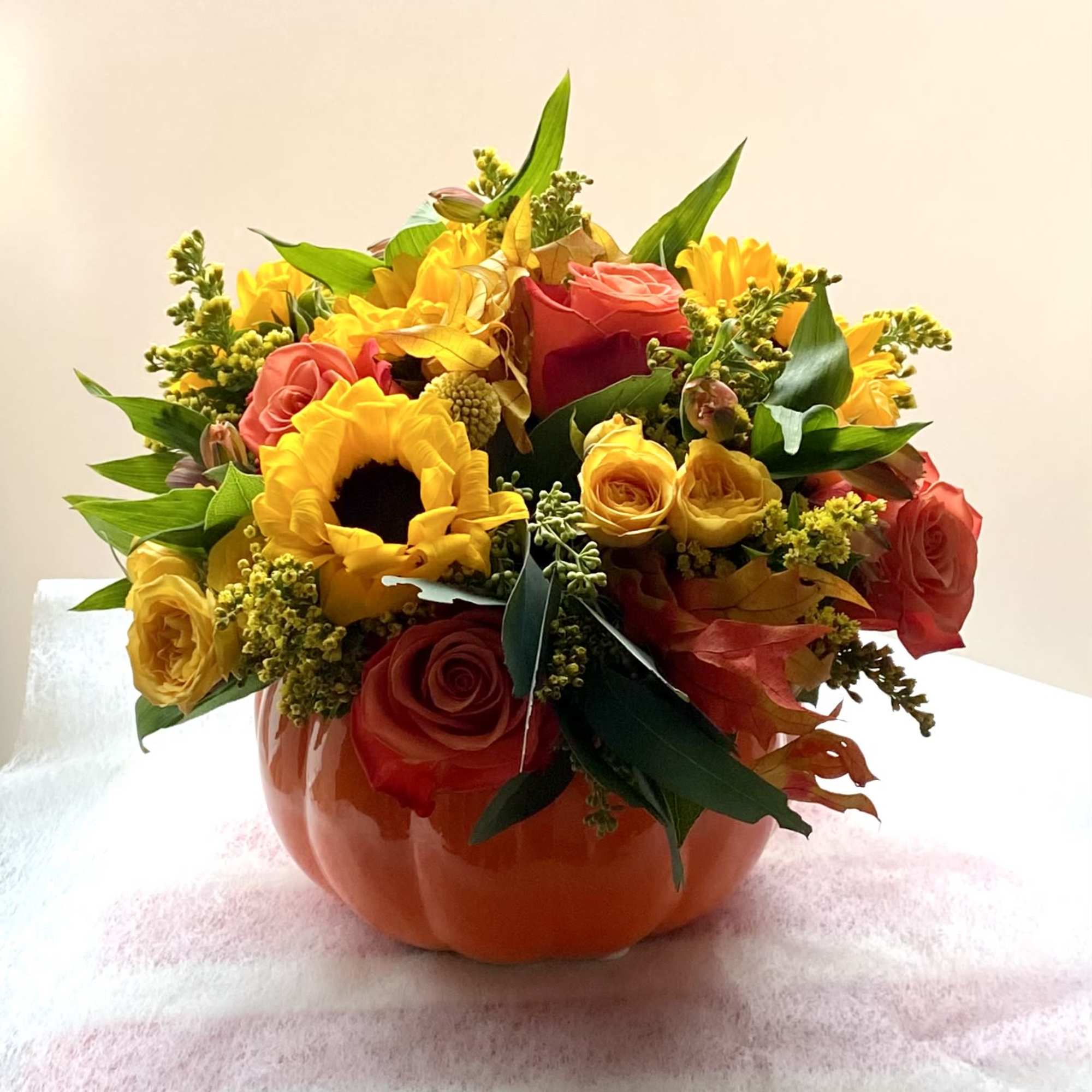 Approximately 11&rdquo; wide, 10&rdquo; tall 

Festive pumpkin with spray roses moms, sunflowers, photo 4 of 4