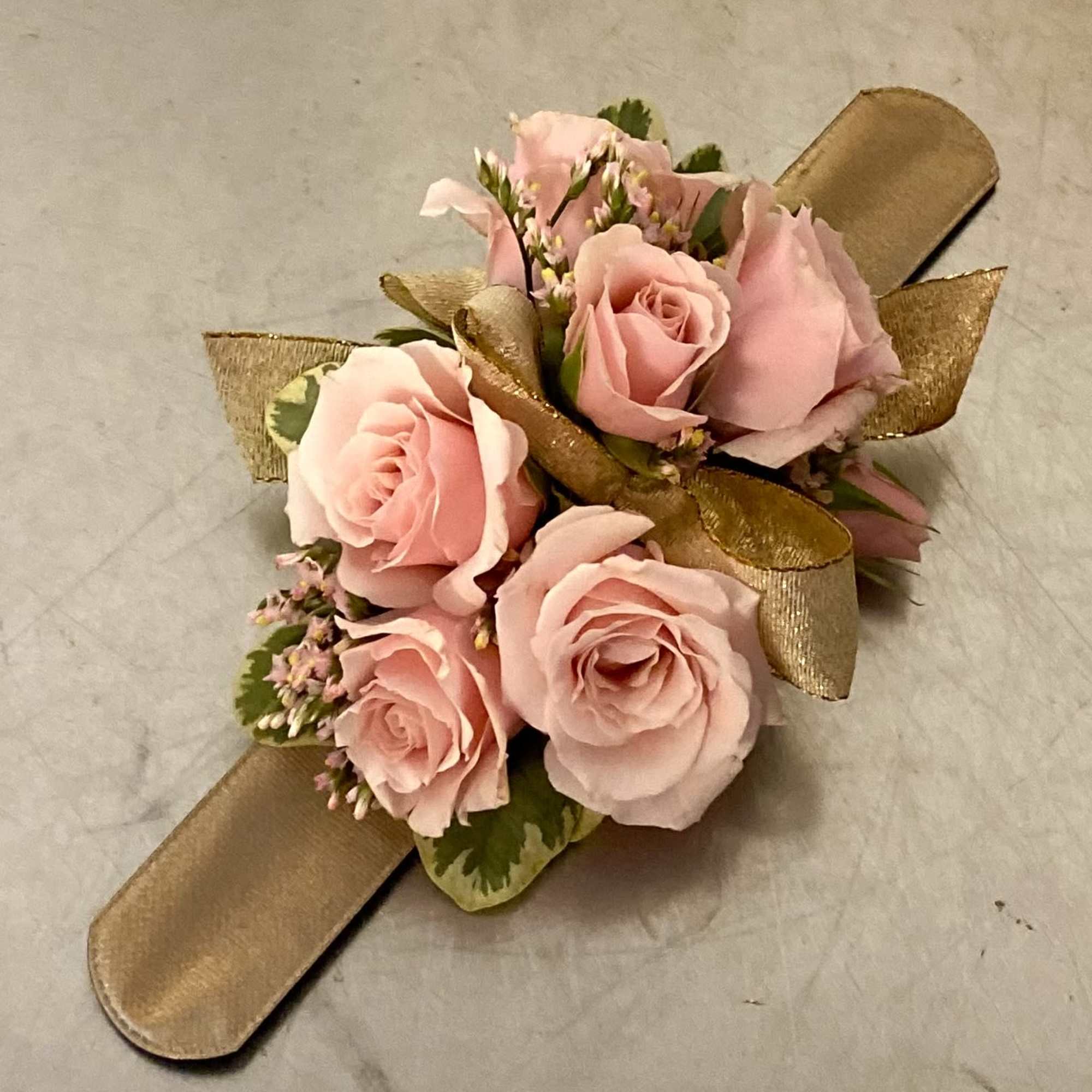 Pink rose wrist corsage with gold ribbon