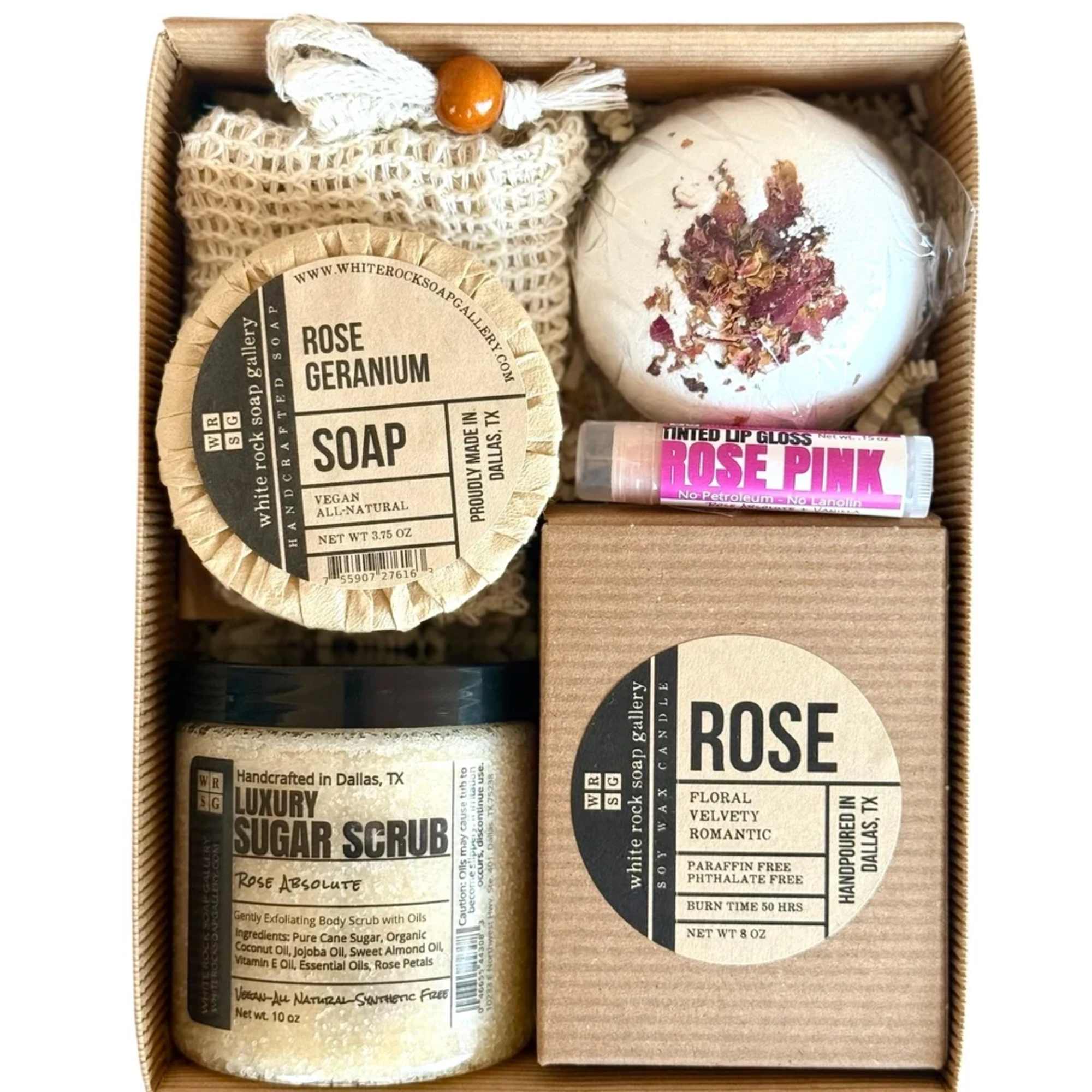 Gift box with rose-scented soap, scrub, candle, lip balm, and a bath bomb