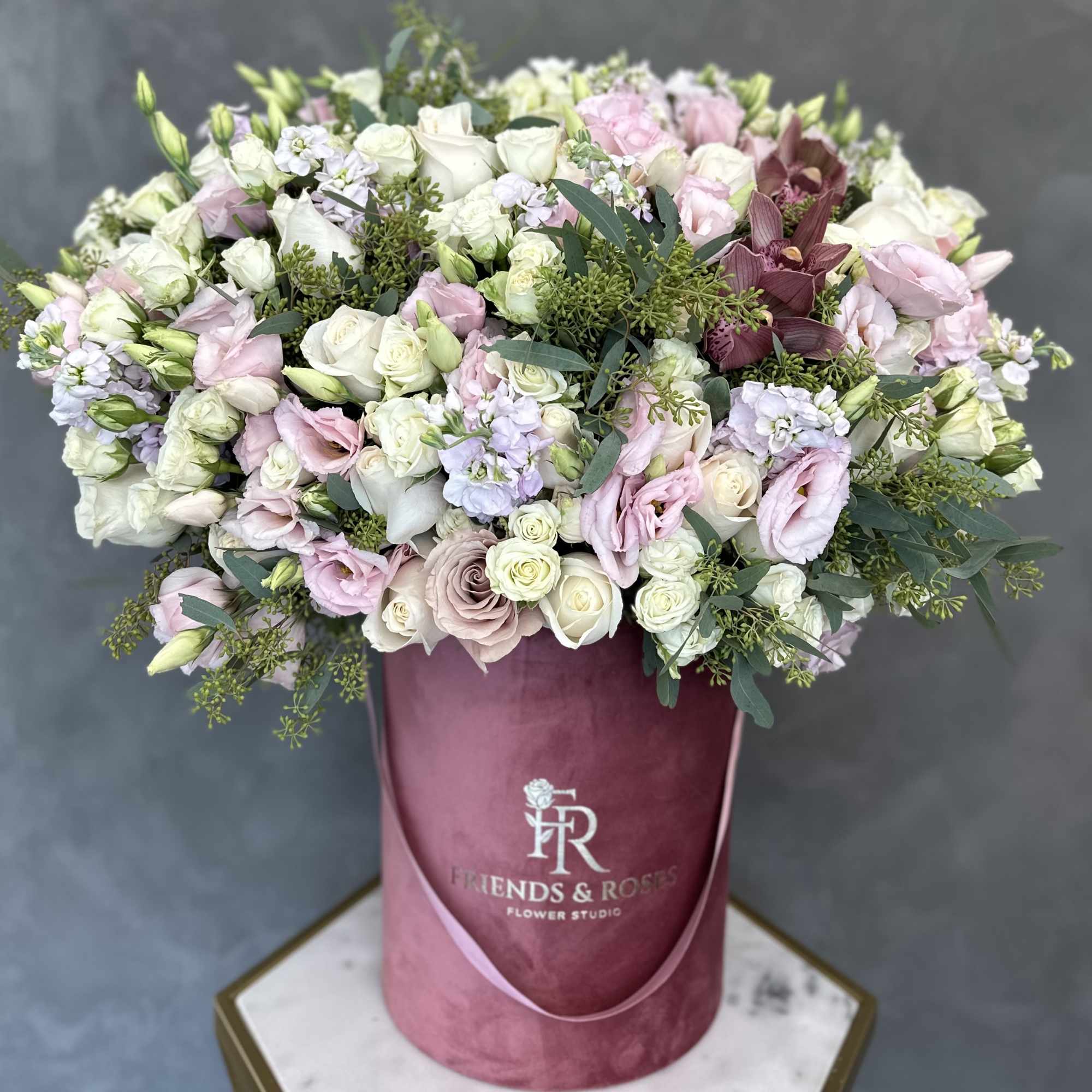 Large pastel bouquet in a pink hat box