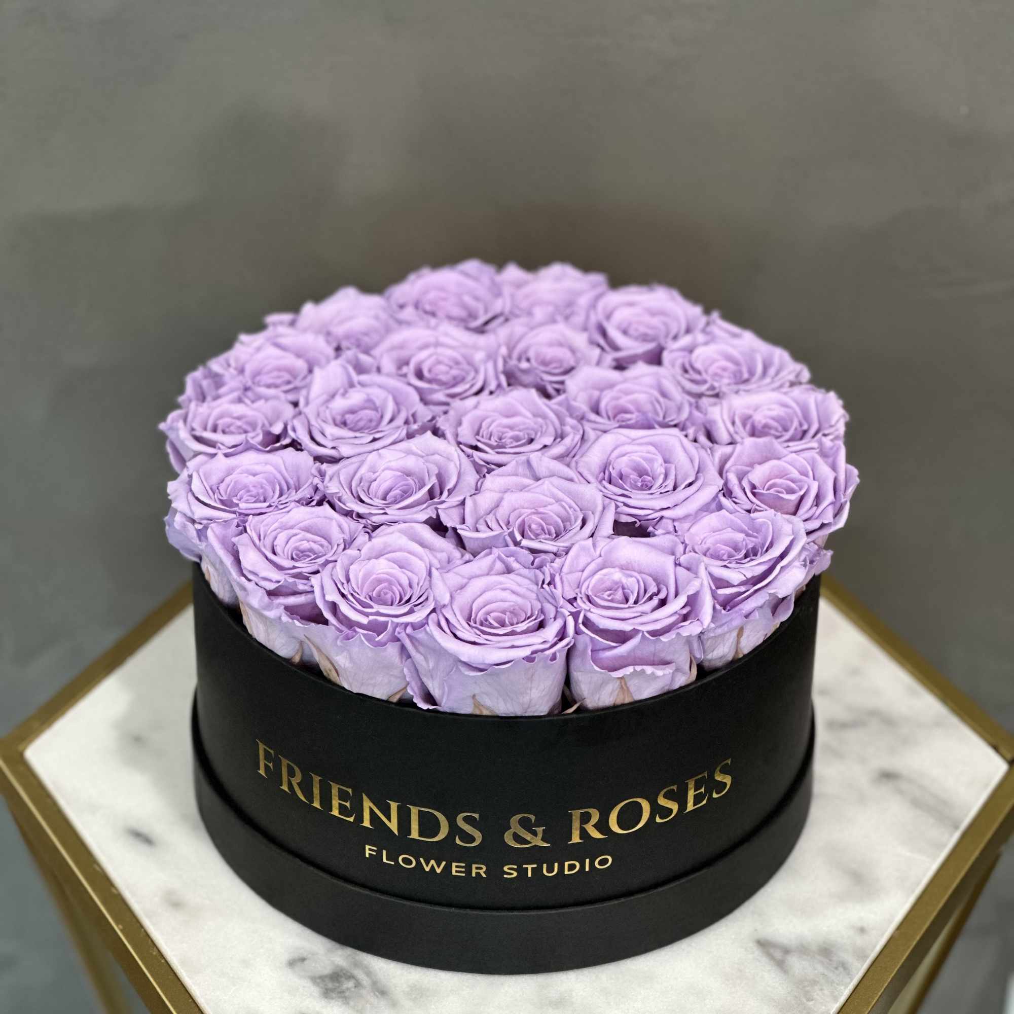 Lavender roses arranged in a round black box, photo 2 of 3