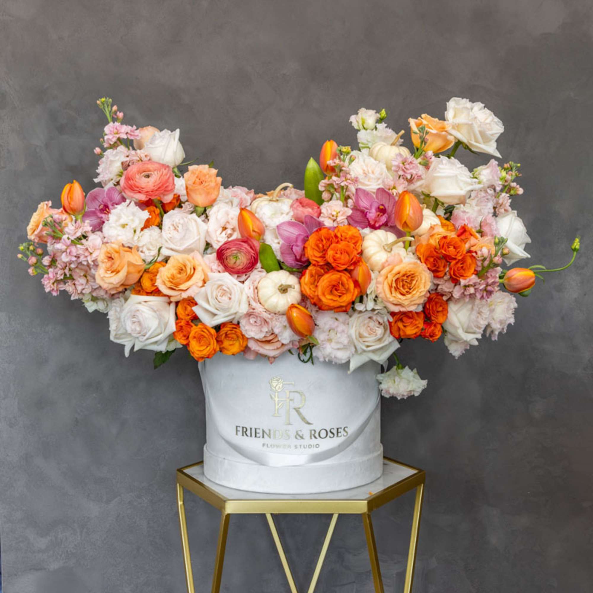 Large mixed bouquet in a white hat box on a gold stand