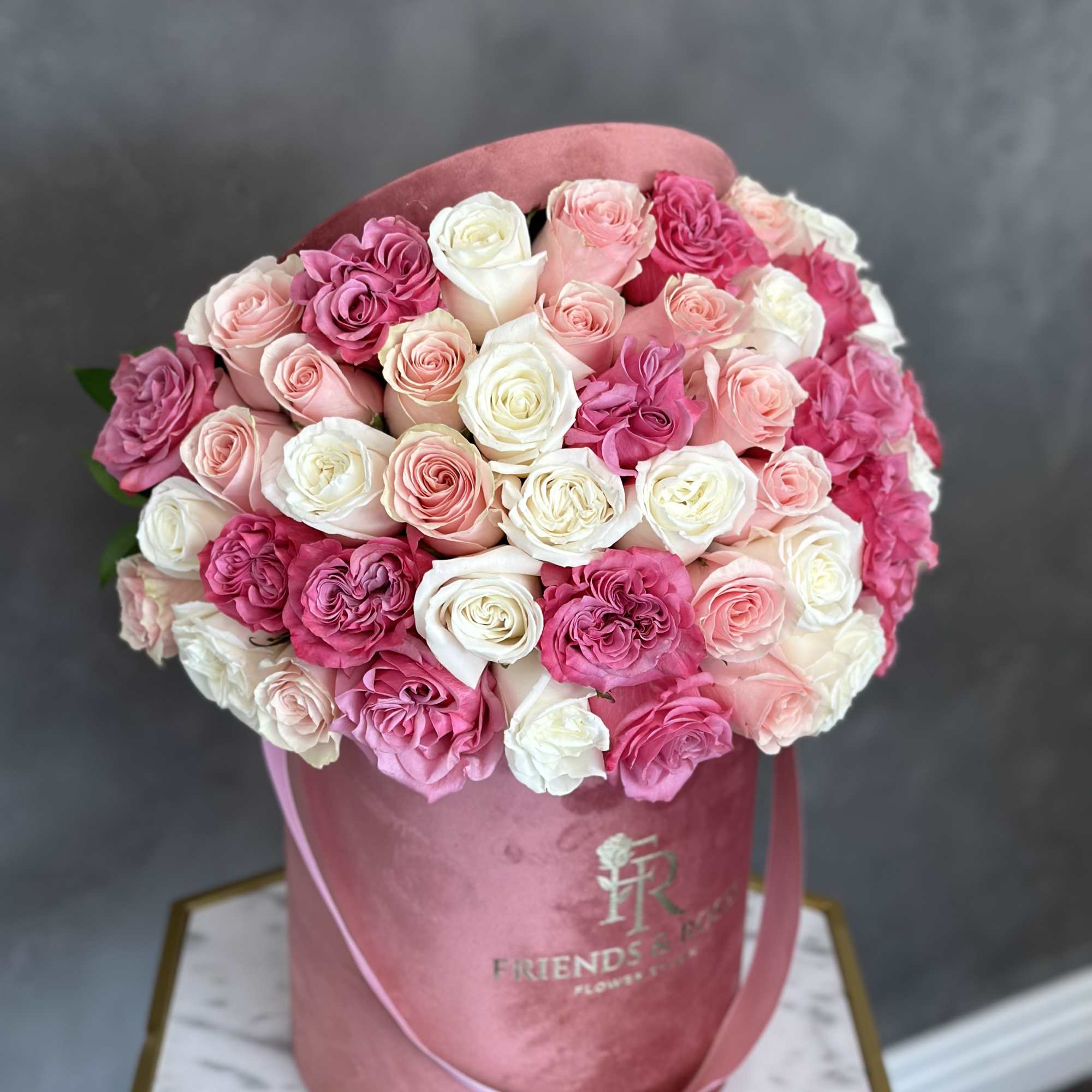 Pink and white rose bouquet in a pink hat box