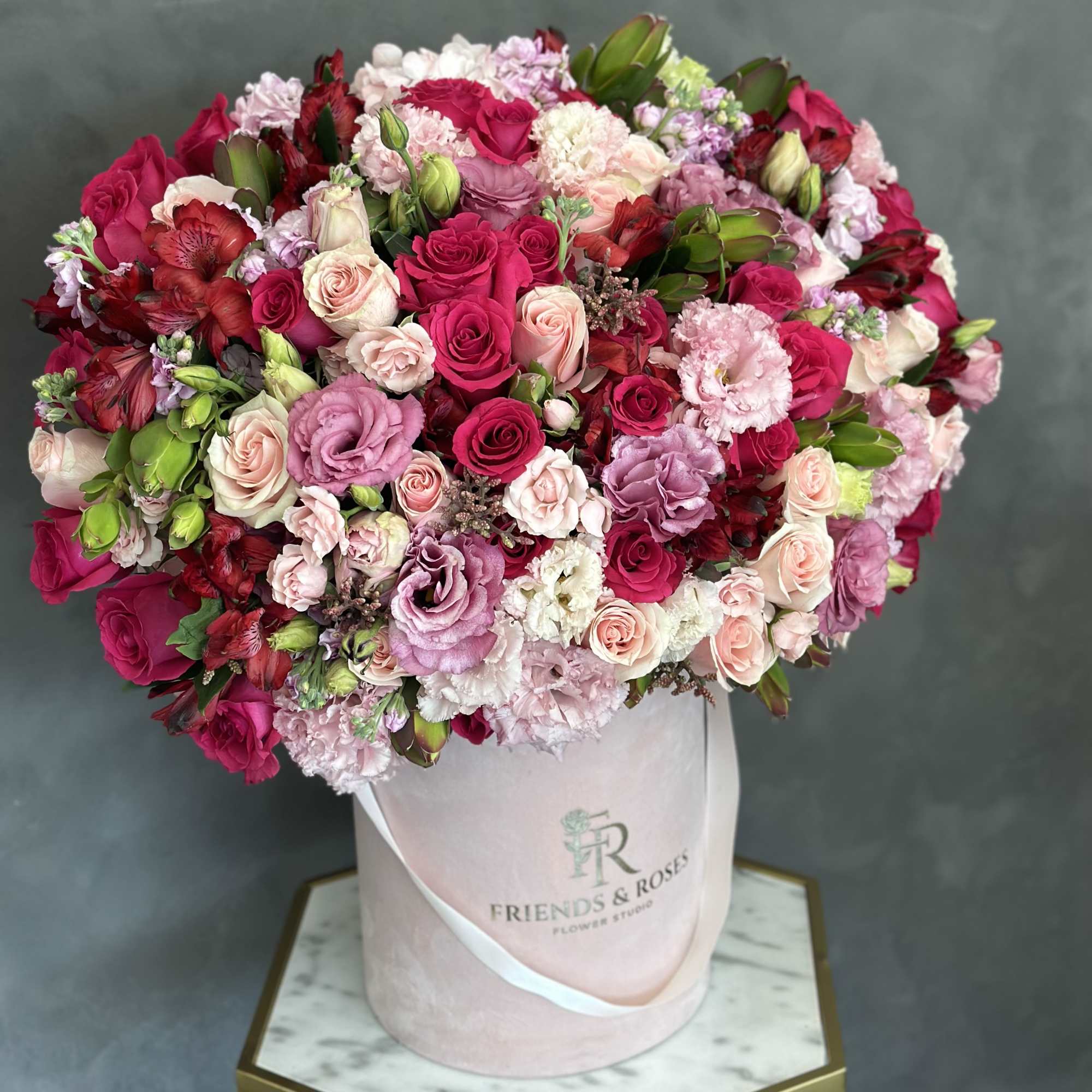 Large pink and red rose bouquet in a pale pink hat box