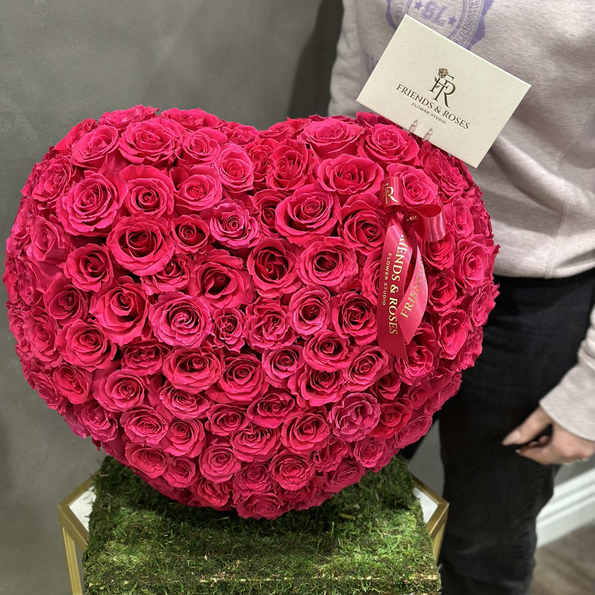 Heart-shaped bouquet of hot pink roses on a moss-covered base, photo 2 of 3