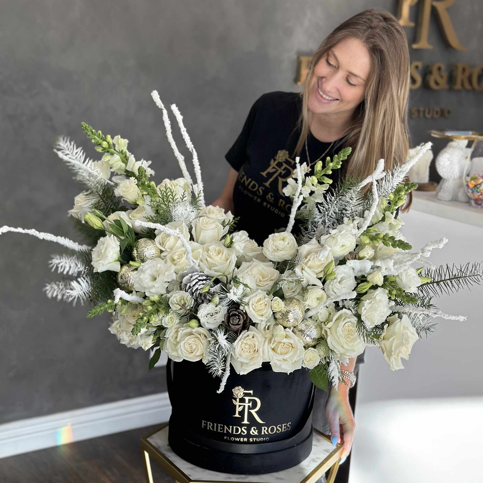 Large white rose arrangement in a black hat box