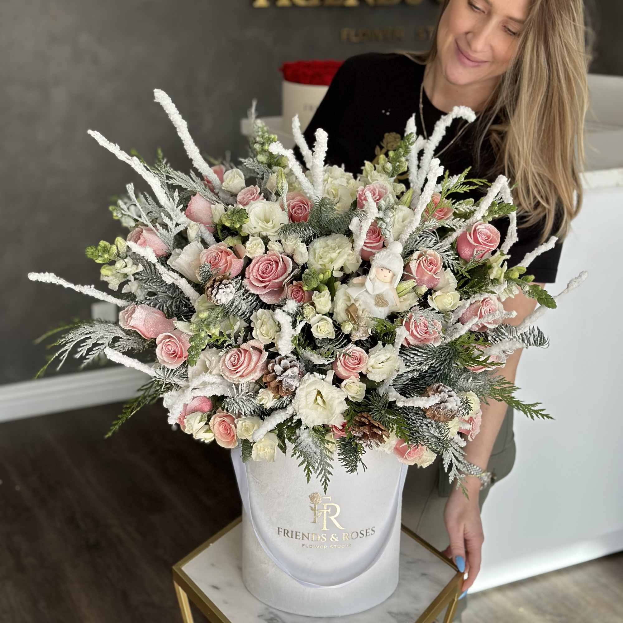 Pink and white roses in a white hatbox with frosted winter accents, photo 2 of 3