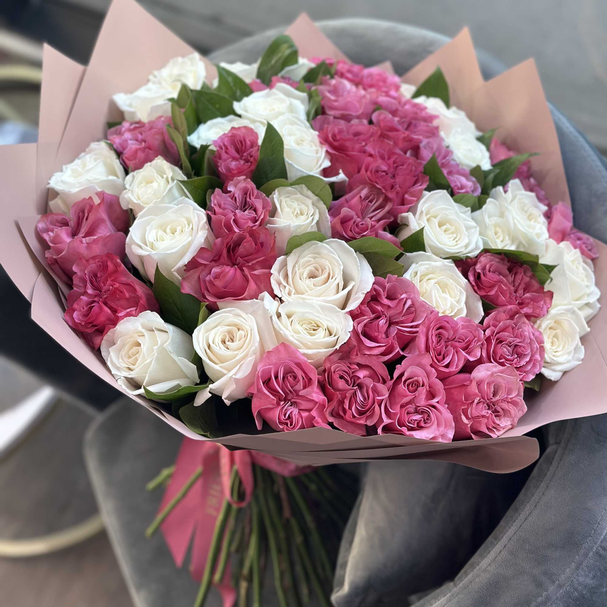 Bouquet of pink and white roses wrapped in blush paper, photo 2 of 2