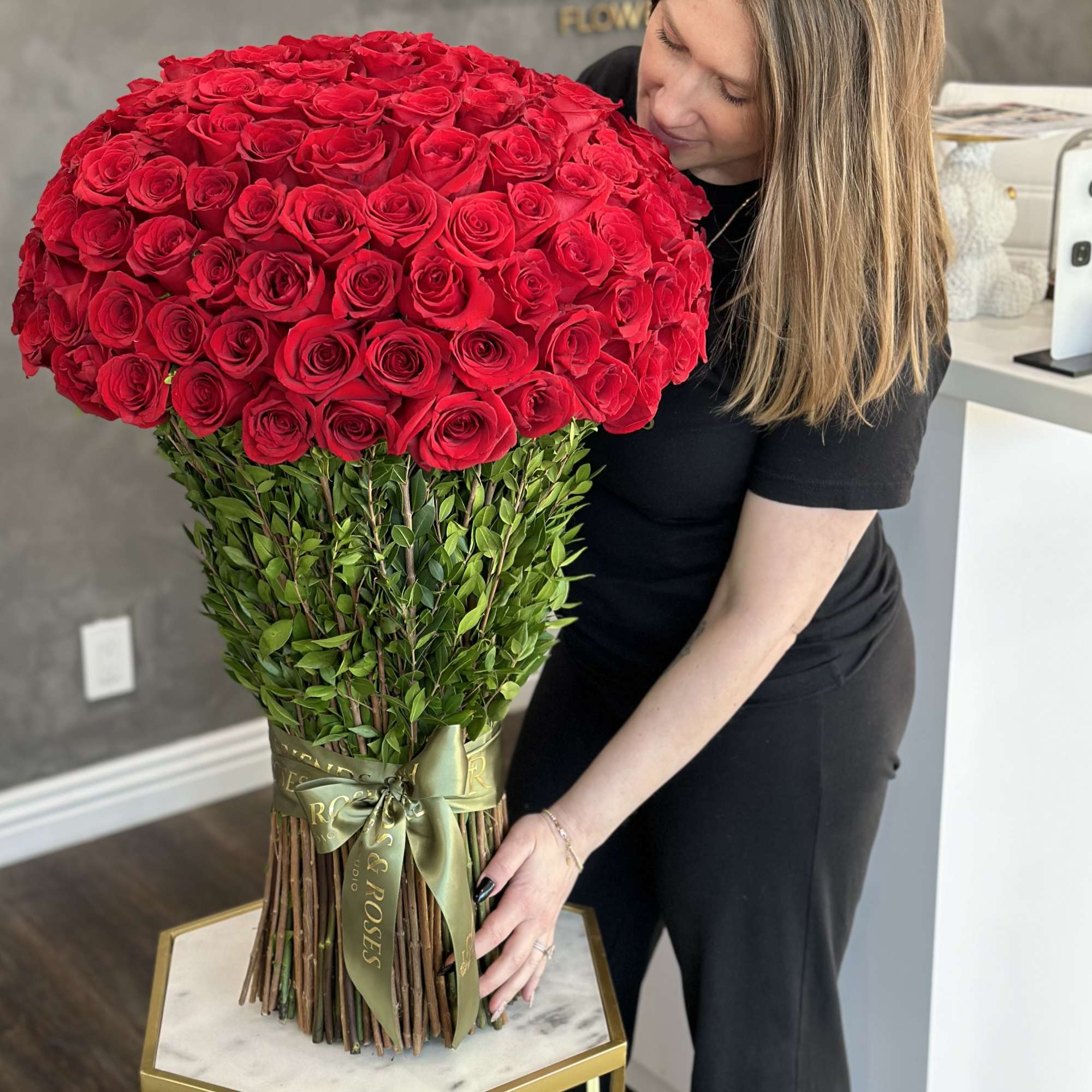 Large bouquet of red roses with a green ribbon