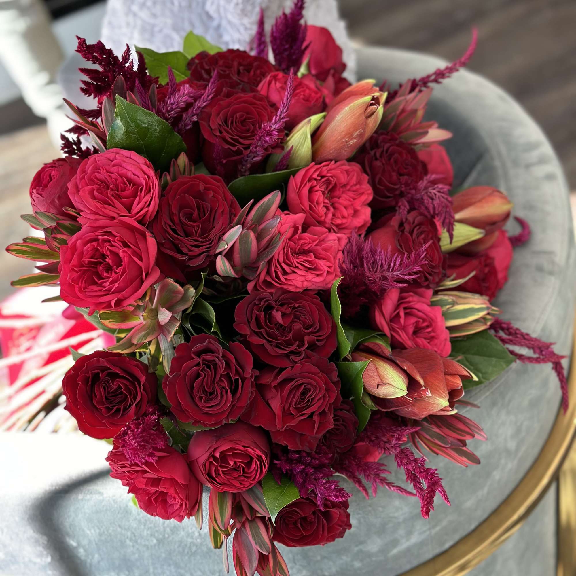Bouquet of red and pink roses with burgundy accents