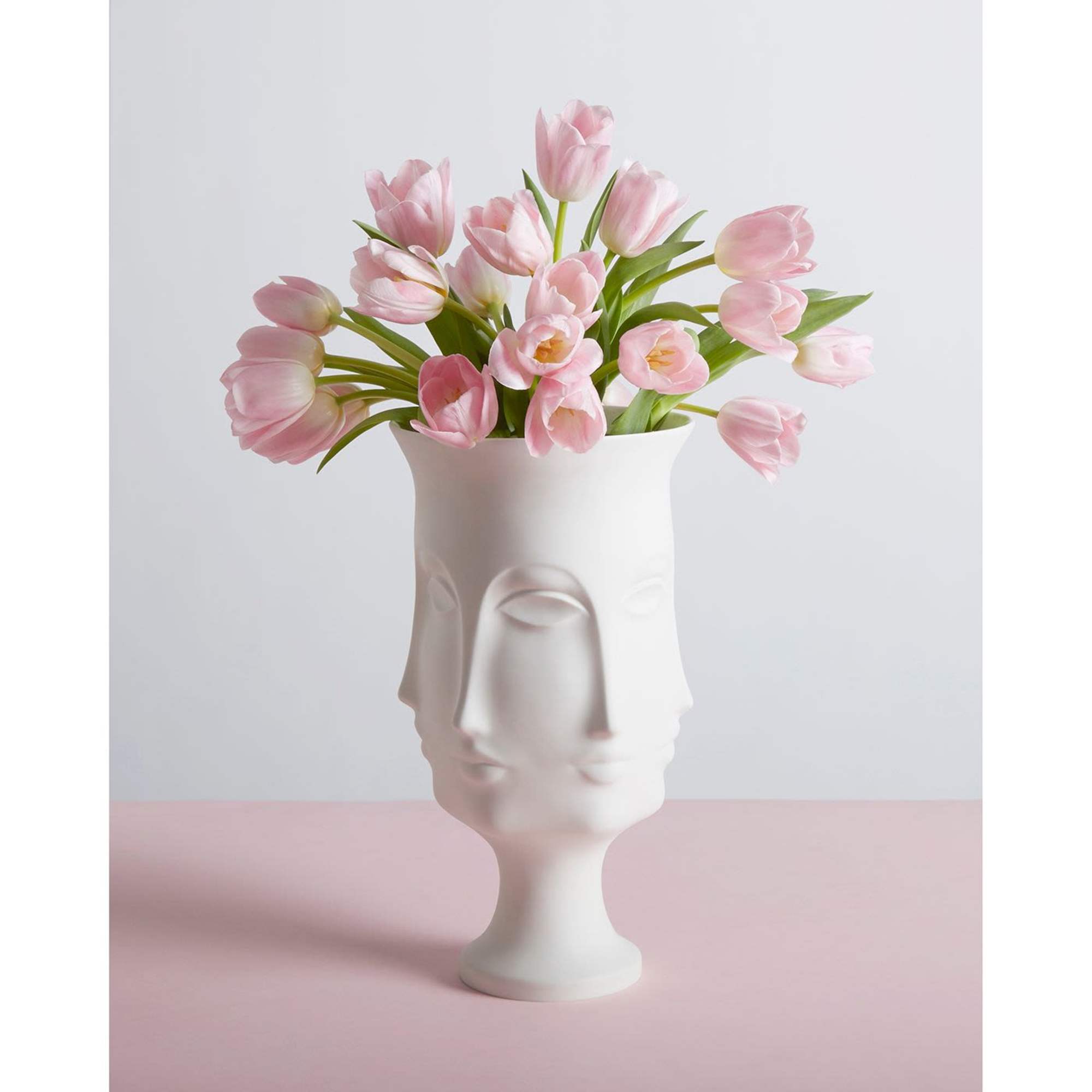 Pink tulips arranged in a white sculptural vase