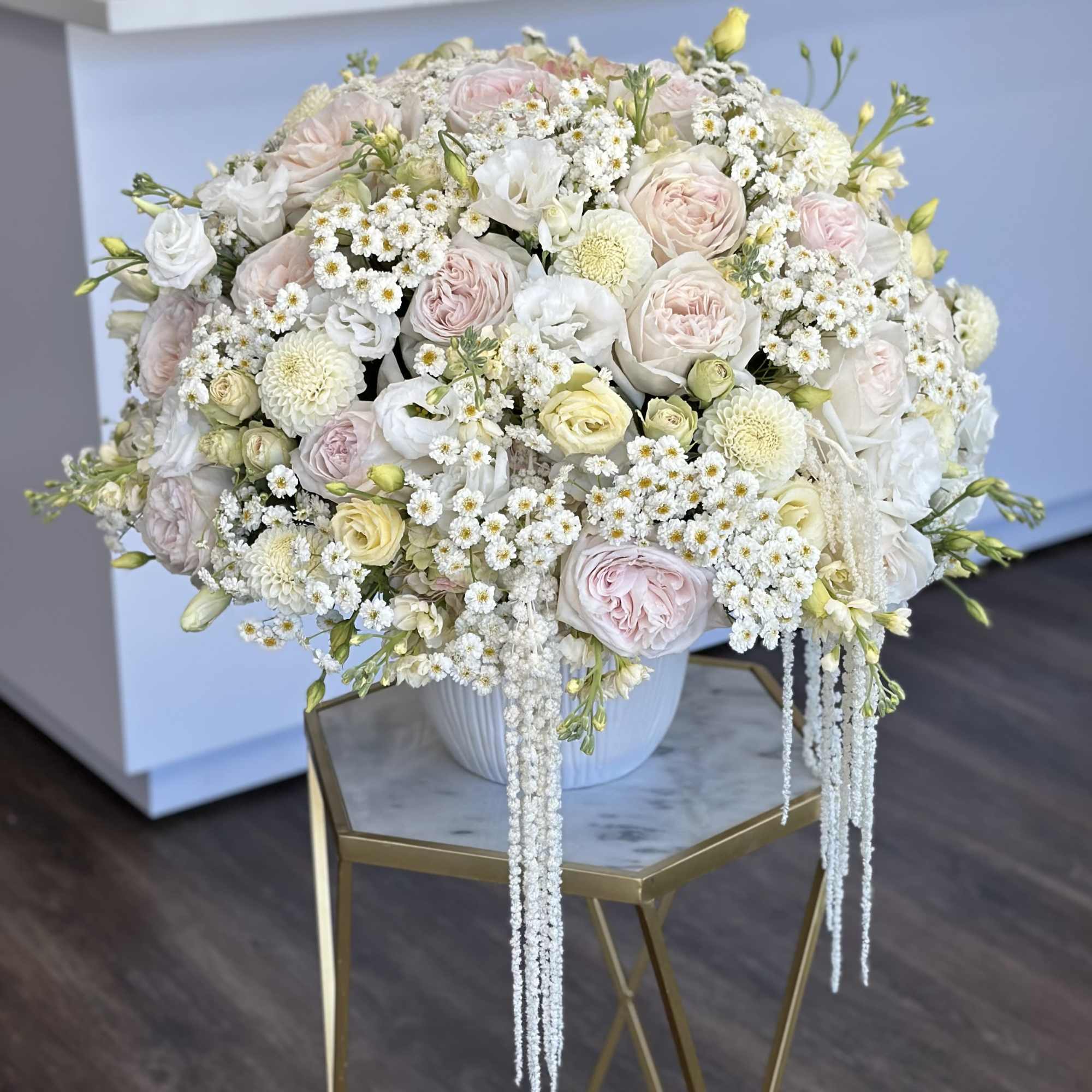Large pastel bouquet of roses and white filler flowers in a white vase, photo 2 of 3