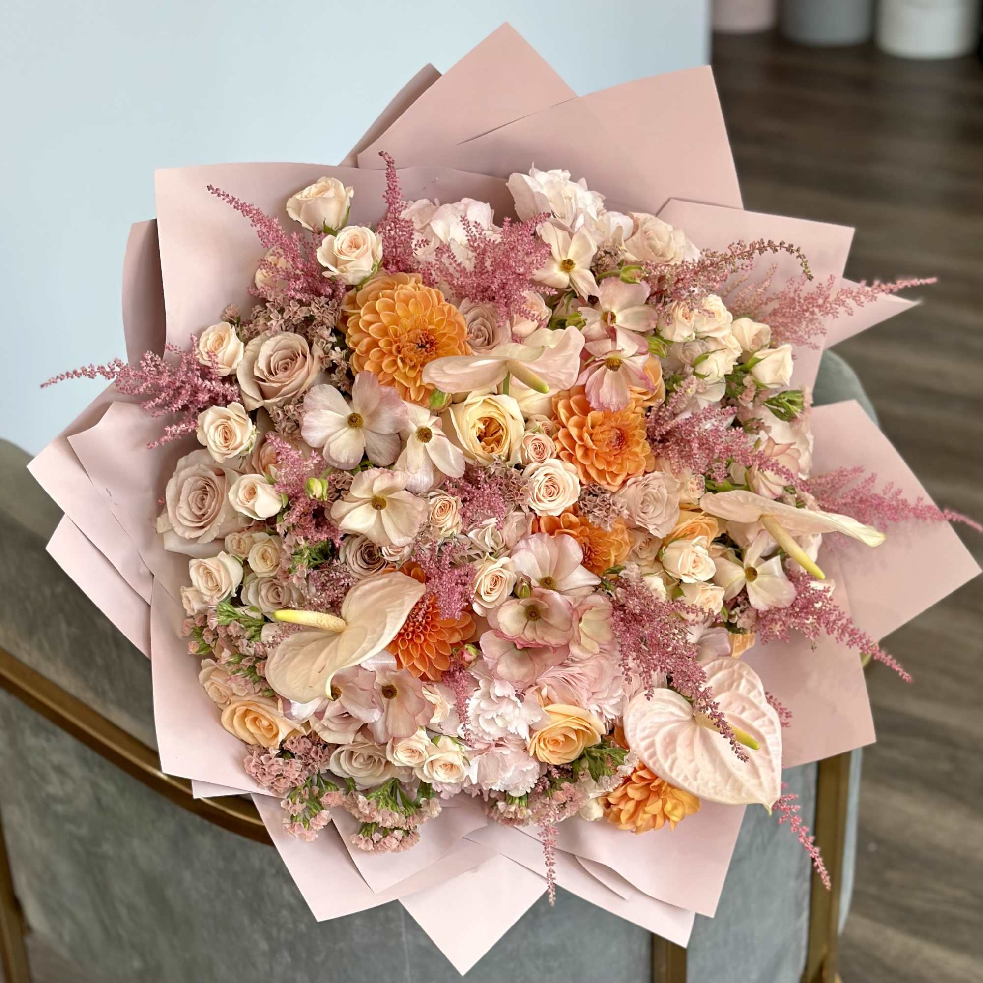 Large pastel bouquet with roses, peach dahlias, and pink filler flowers