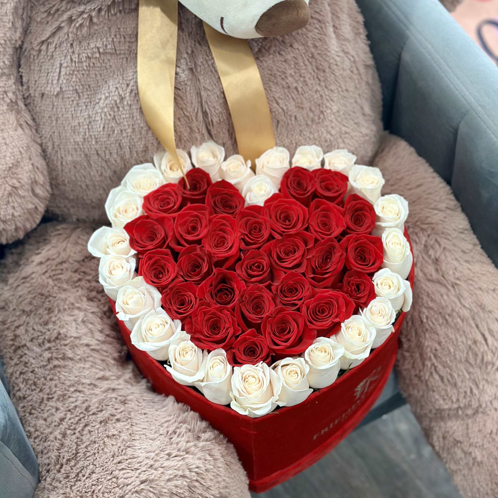 Heart-shaped box of red and white roses with ribbon handles