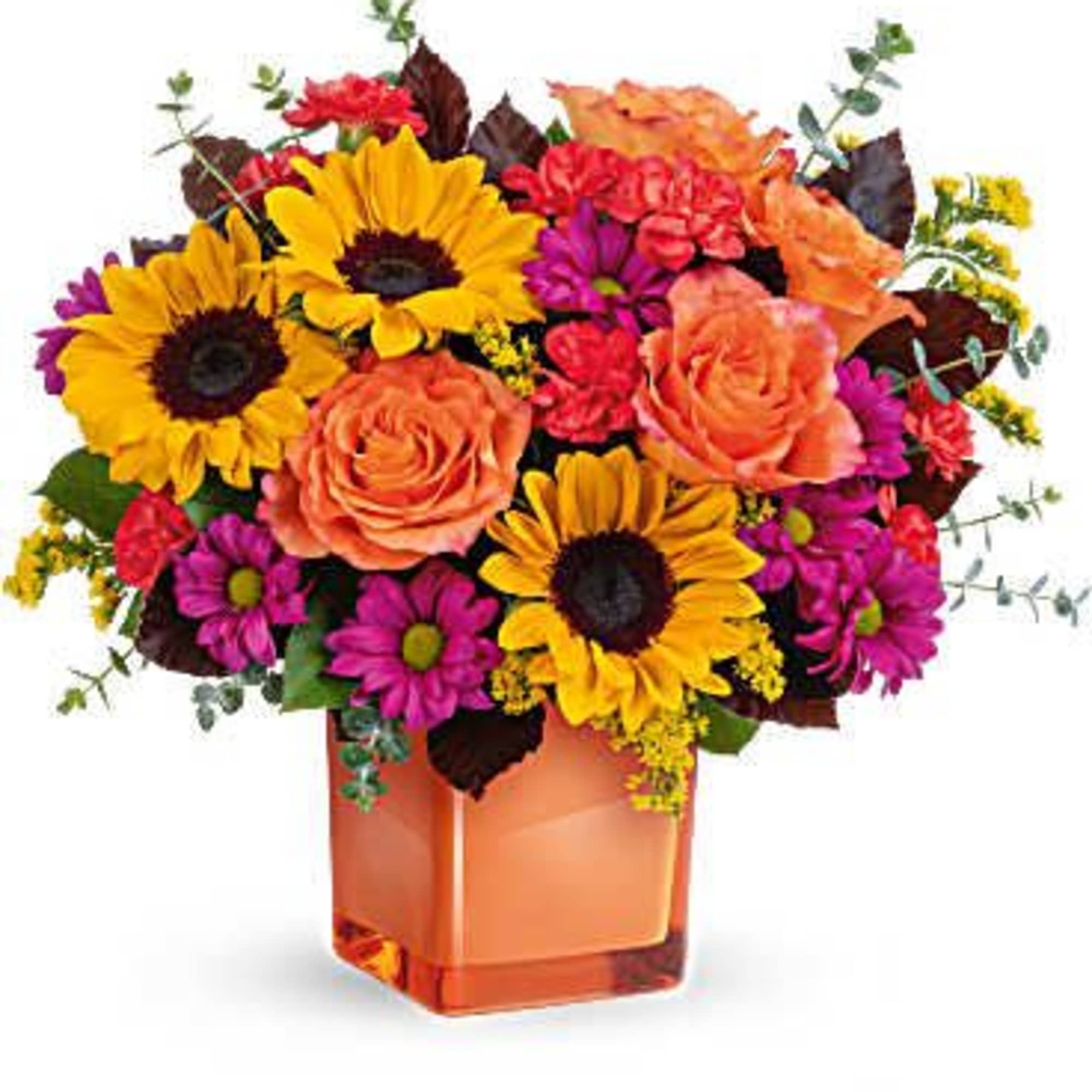 Bouquet of sunflowers, roses, and daisies in an orange glass vase