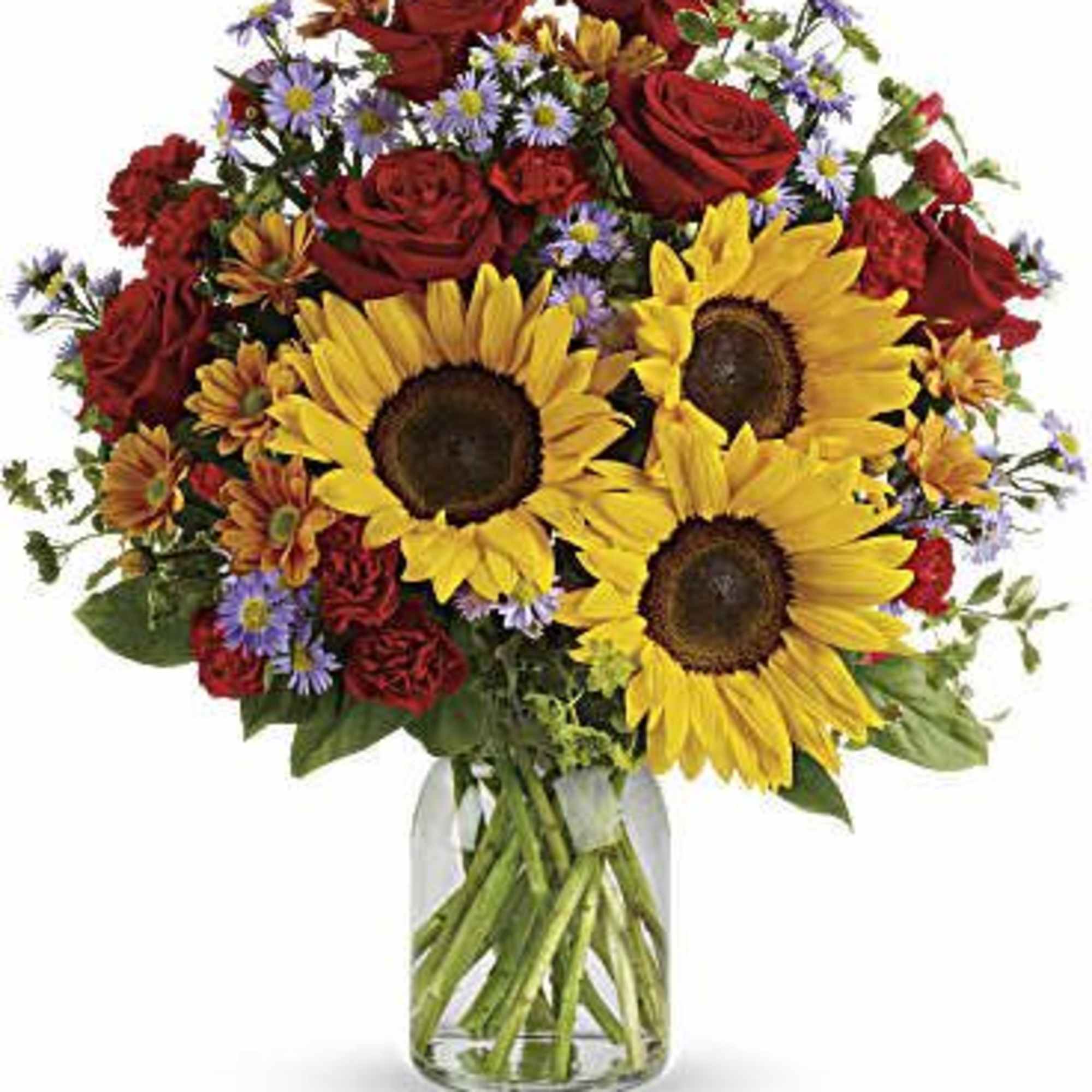Bouquet of sunflowers, red roses, and purple daisies in a glass vase